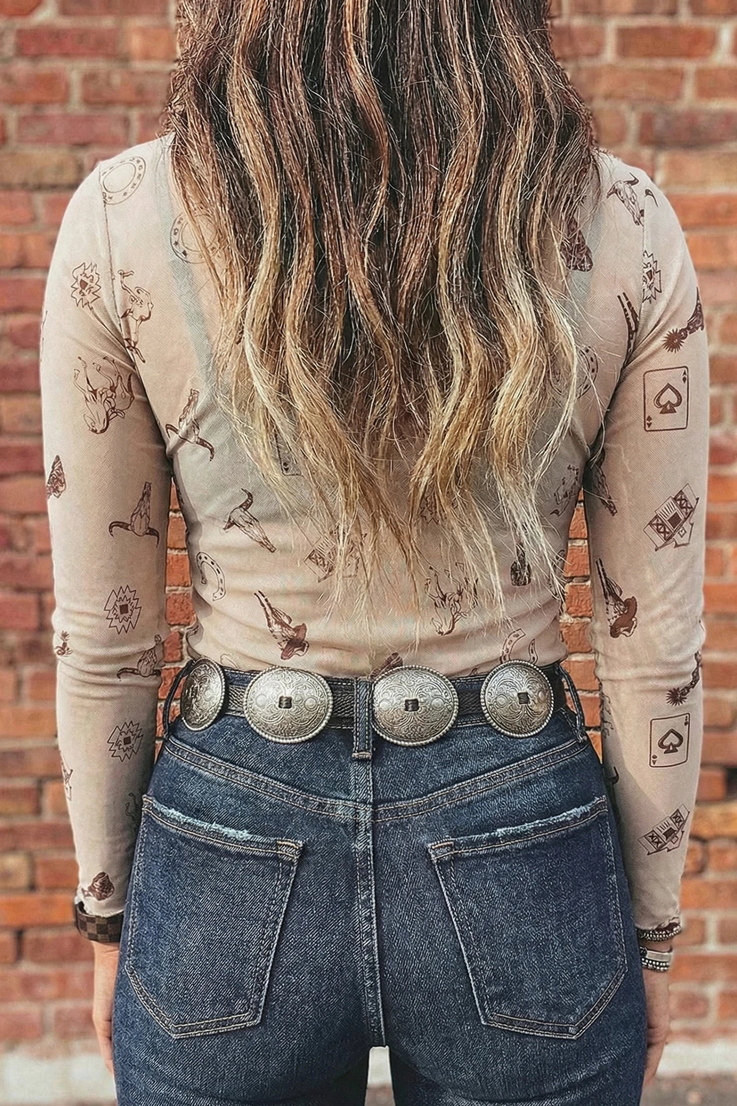 WOMEN WEARING BEIGE AND BROWN COWBOY MESH LONGSLEEVE SHIRT WITH JEANS AND CONCHO BELT