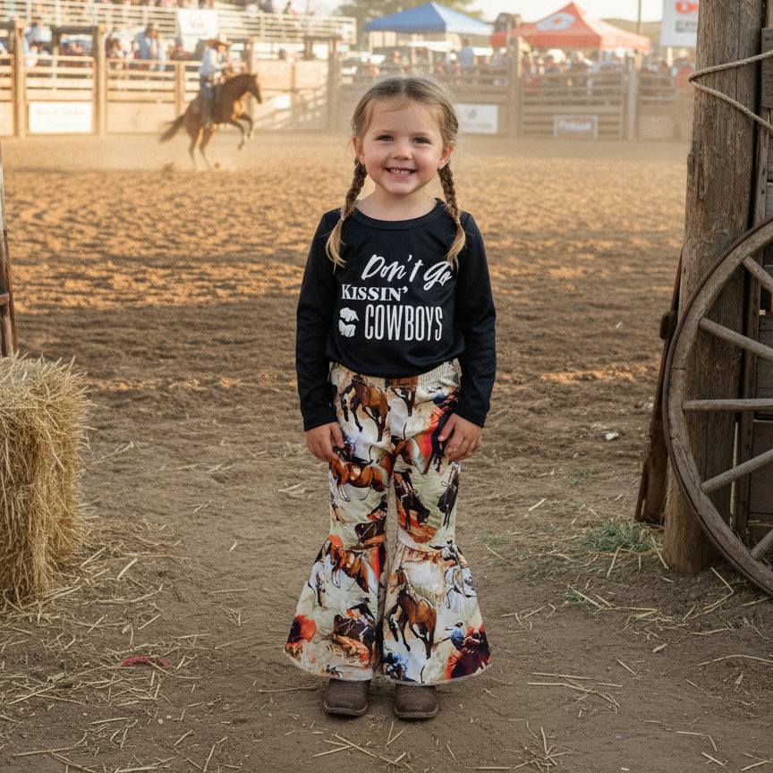 girl standing at rodeo wearing Don’t Go Kissing Cowboys Bell Bottoms | Cowboy Rodeo Flare Pants
A fun and sassy outfit for our little cowgirls (and a good reminder for the rest of us!) 🤠💋 These Cowboy Rodeo Flare Pants bring the perfect mix of Western charm and trendy style!
✔ True to Size Fit – Comfortable & flattering.