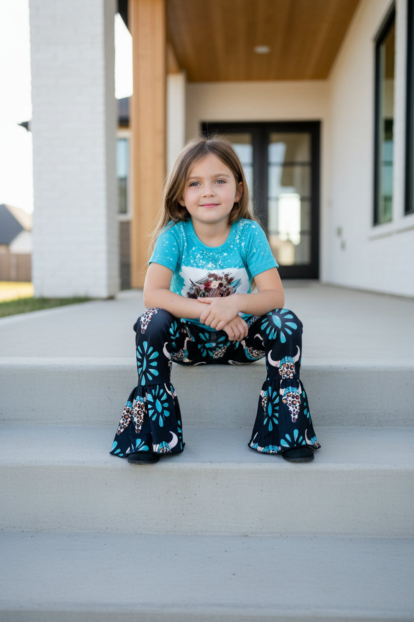 girl sitting on steps wearing COW TSHIRT BELL BOTTOM OUTFIT, COWGIRL OUTFIT