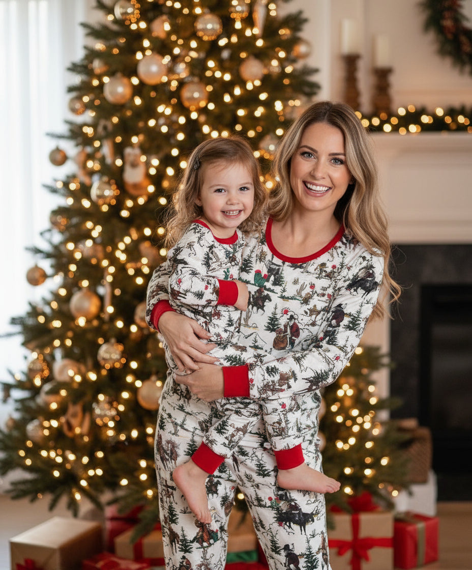 Cowboy Santa Christmas pajamas feature Cowboy Santa delivering packages on his trusty horse, riding among the trees and mountains. The cuffs of the long-sleeve top and pajama pants, as well as the neckline, are red.