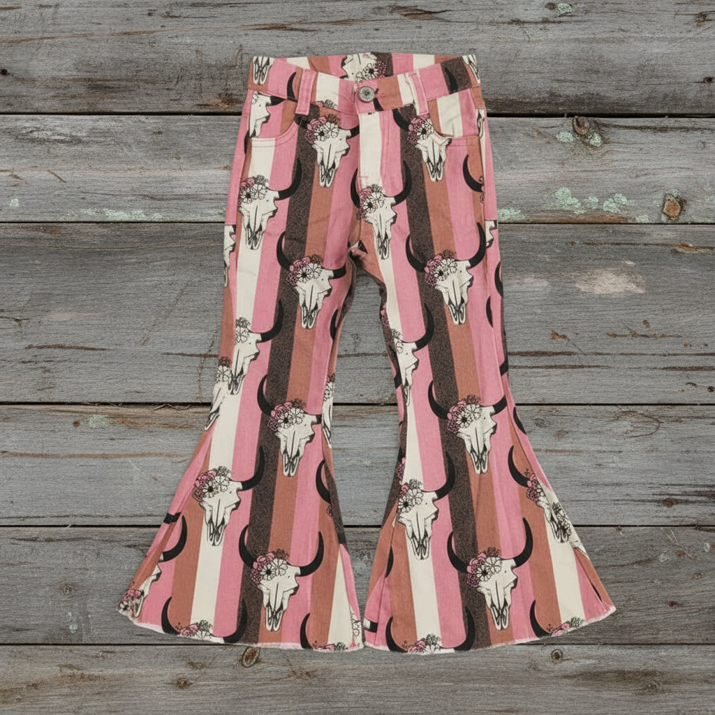 Flared pants with bull skull pattern on a textured white background