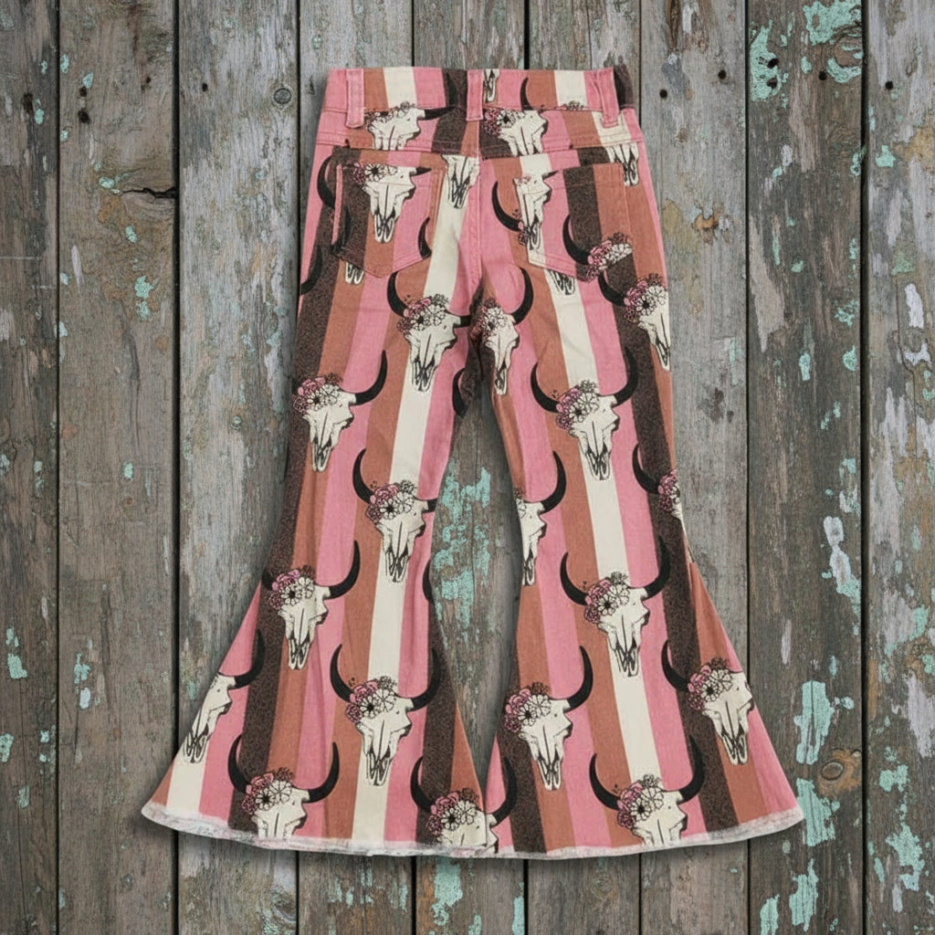 Flared pants with bull skull pattern, stripes and flowers on a textured white background