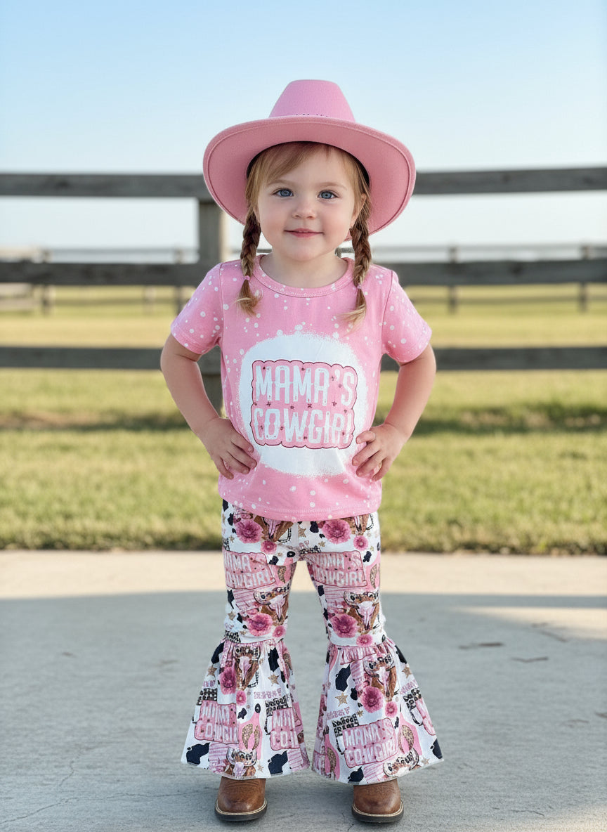 Mama’s Cowgirl Bell Bottom Outfit features a pink bleach-splattered tee with Mama's Cowgirl on the front and the bell bottom pants feature the funnest cowgirl motif with cheetah rodeo back numbers, disco balls, cow skulls, cowprint, and gold stars!