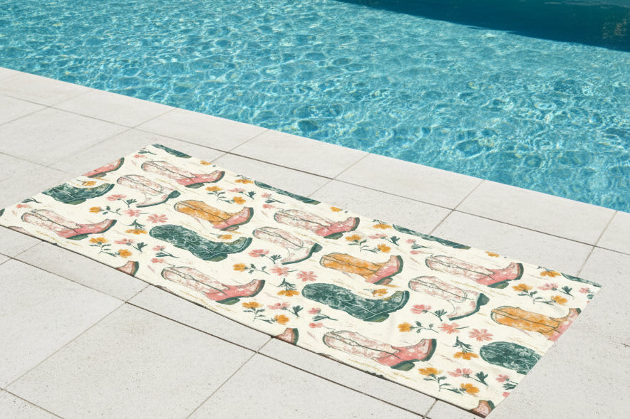 Patterned towel with cowboy boots and flowers on a beige background