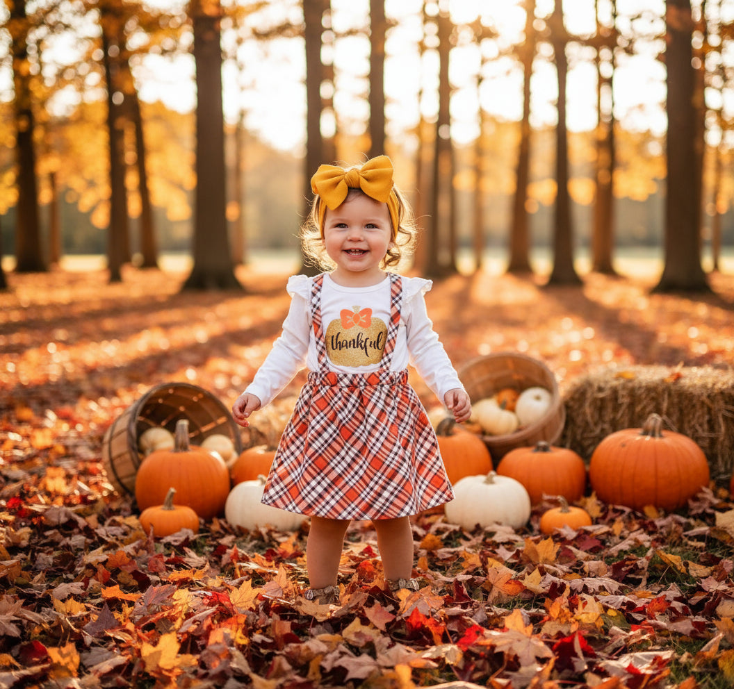 Toddler Girl Thanksgiving Outfit – “Thankful” Ruffle Top & Plaid Suspender Skirt Set
Oh my pumpkins! This adorable two-piece brings all the cozy fall vibes—perfect for pumpkin patch pics, school parties, and Turkey Day dinner.
✓ Thankful Top – glittery gold pumpkin with “thankful” + sweet ruffle sleeves
✓ Plaid Suspender Skirt – adjustable front ties with back loop for a secure, custom fit
✓ Mix & Match – layer with tights, boots, and a cardigan for peak fall style