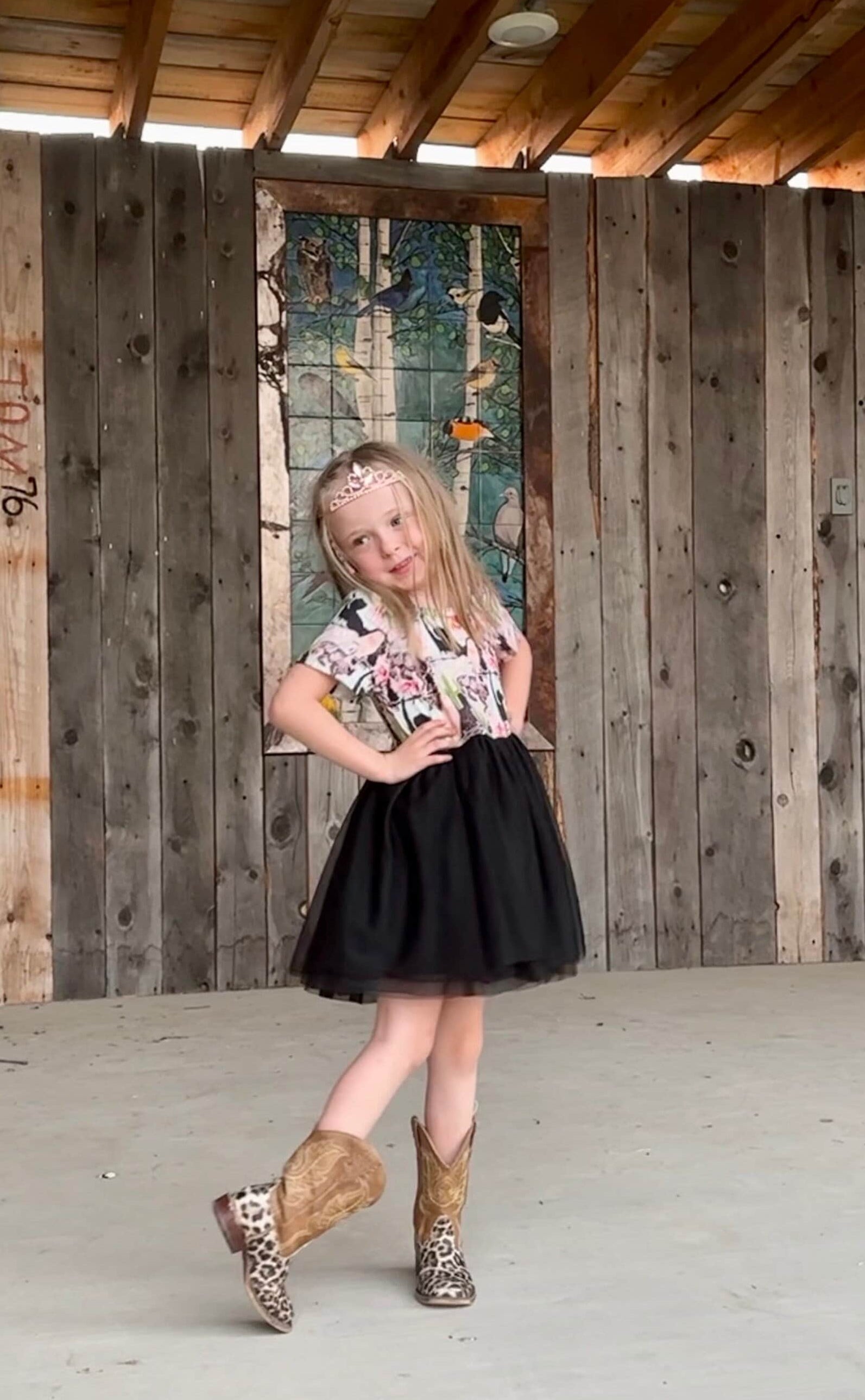 Western TUTU Cowgirl Party Dress modeled by Jernie. The dress features a super soft t-shirt-like top with a western print and the attached skirt is 3 layers of black tulle. Talk about a girl's western party dress!