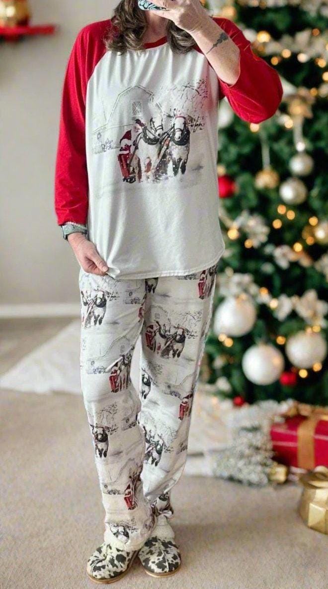 White Christmas pajamas featuring Santa at the reins of his horse-drawn sleigh! The top has red baseball-style sleeves. Comfortable fit, unisex family Christmas pajamas.