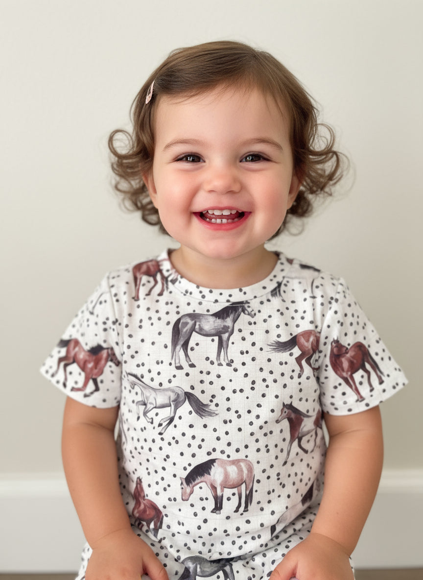 young girl modeling Razels horse and polka dot t-shirt dress