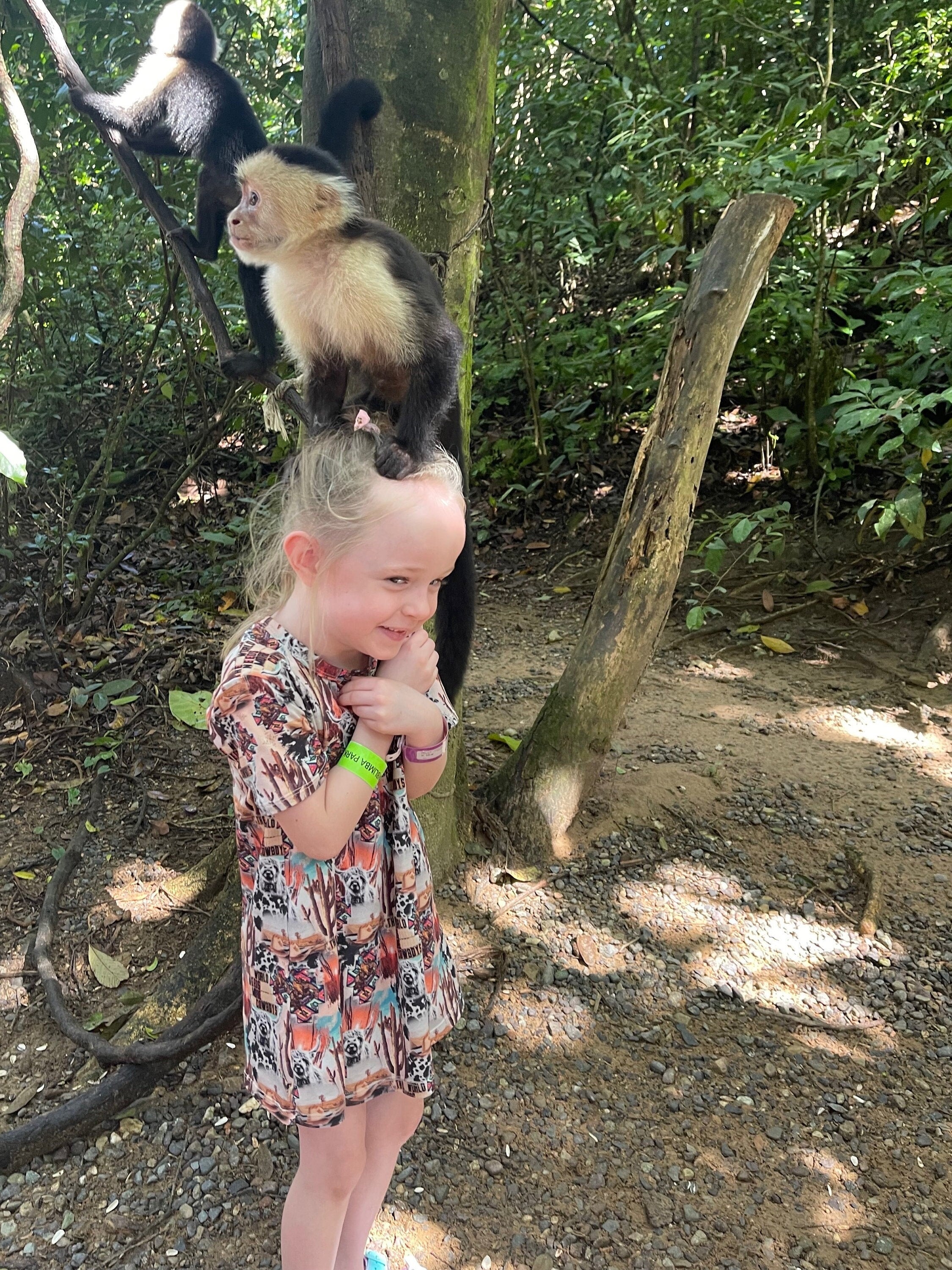 Jernie wearing Razels world needs more cowboys tshirt dress with a Monkey on her head while on vacation to Honduras. T-shirt dresses are so comfy for everyday, travel, school and more!
