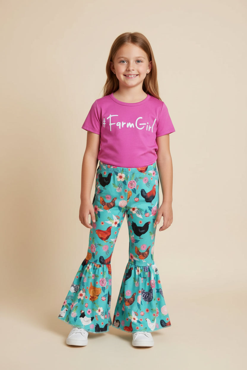 Pink '#FarmGirl' t-shirt and teal floral pants with chicken design on a white background