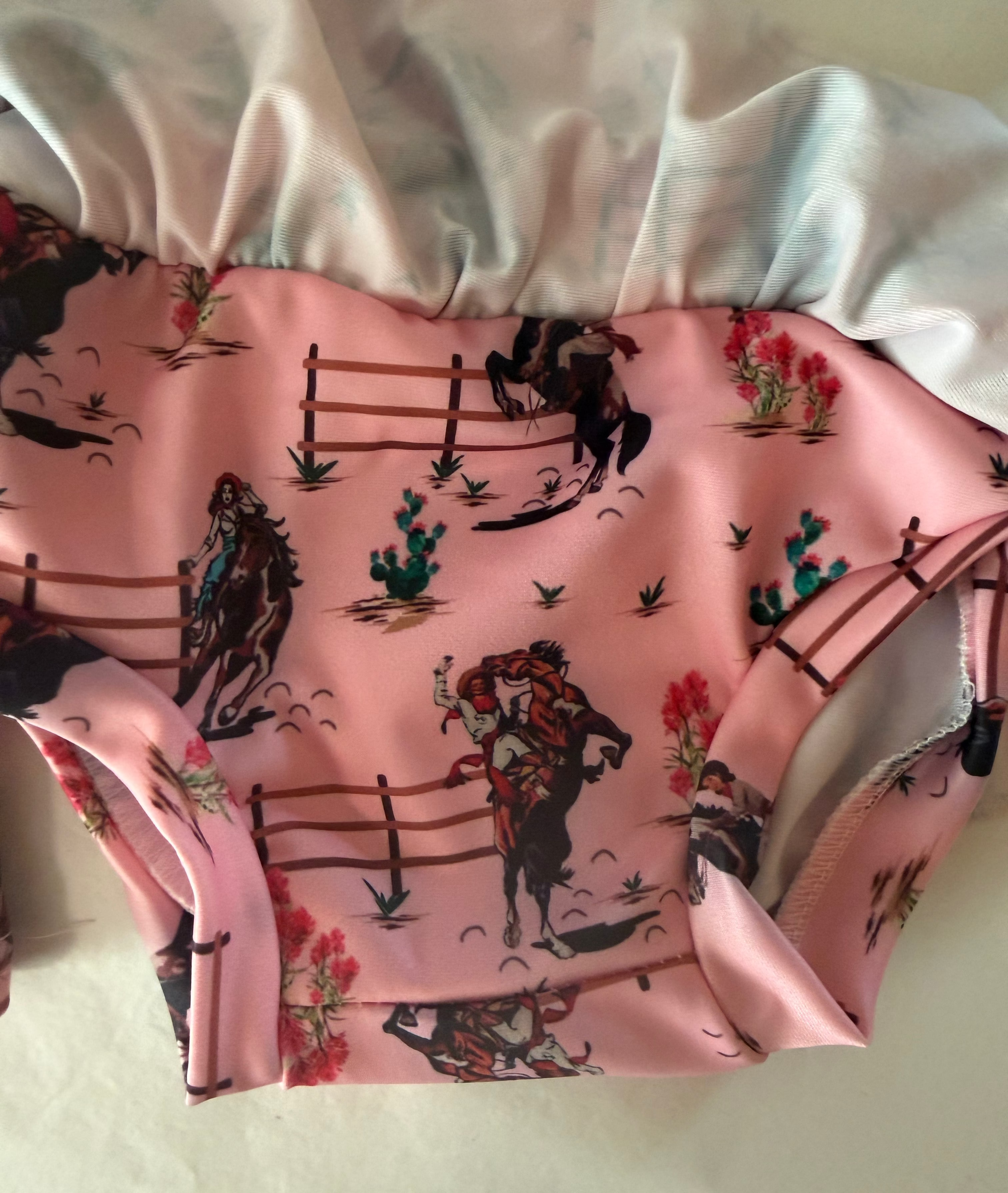 pink cowgirl tankini is well made with folded seams, a skirt and adorable cowgirl print!