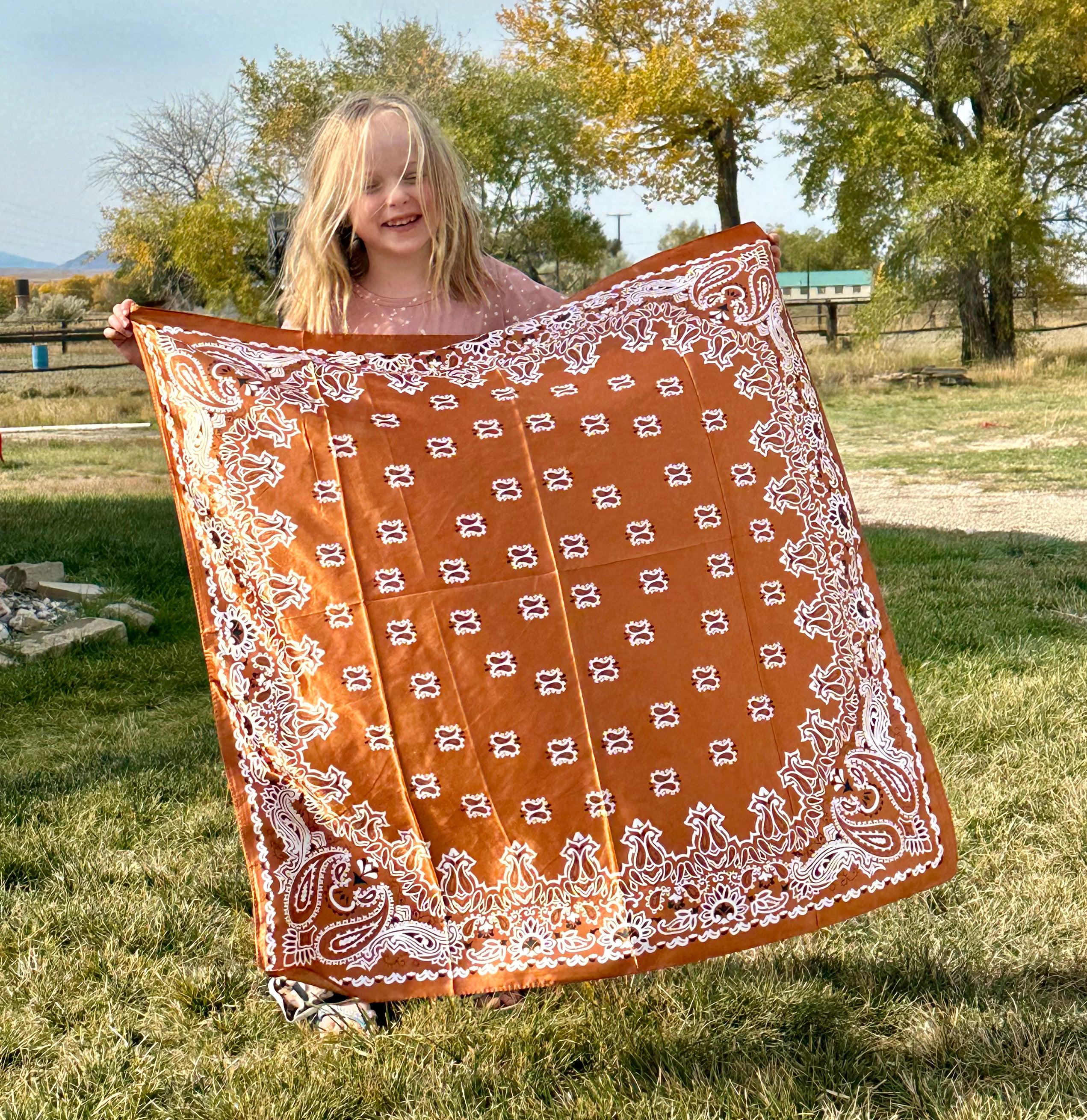 Elevate your style with this vintage-inspired paisley scarf, with a luxuriously soft feel. Measuring 35" x 35", this versatile square Wild Rag scarf offers endless styling possibilities, adding a touch of Western flair to any outfit.