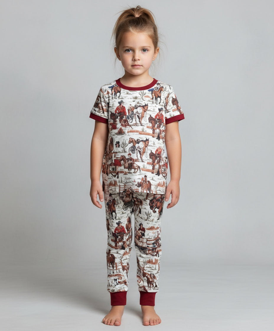 A cowgirl pajama set featuring a cheerful design of a cowgirl who can rope, ride broncs, and sing—complete with her trusty horse and dog by her side! Cute and soft and also available in matching mom size!