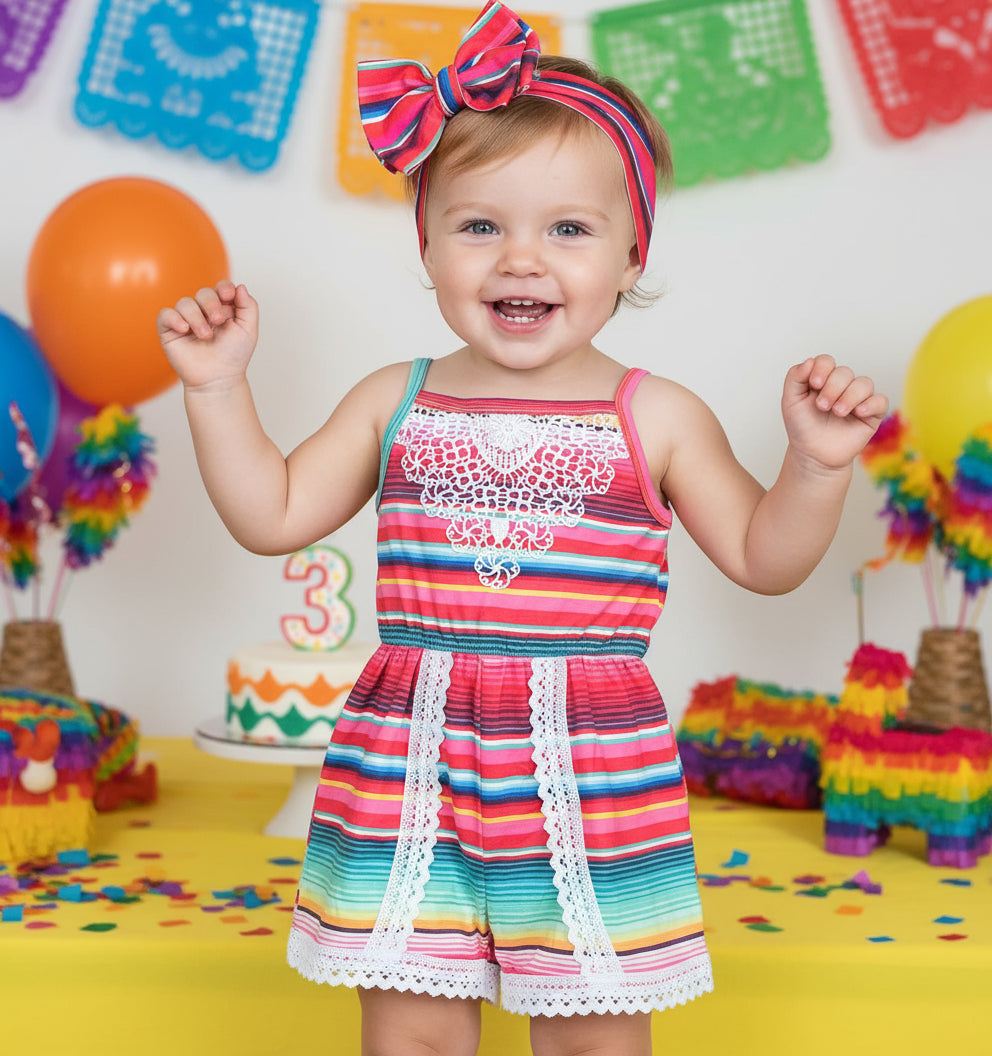 young girl celebrating her three-esta birthday party wearing Girls Pink Striped Romper: Serape Fiesta Lace Jumpsuit -Razels