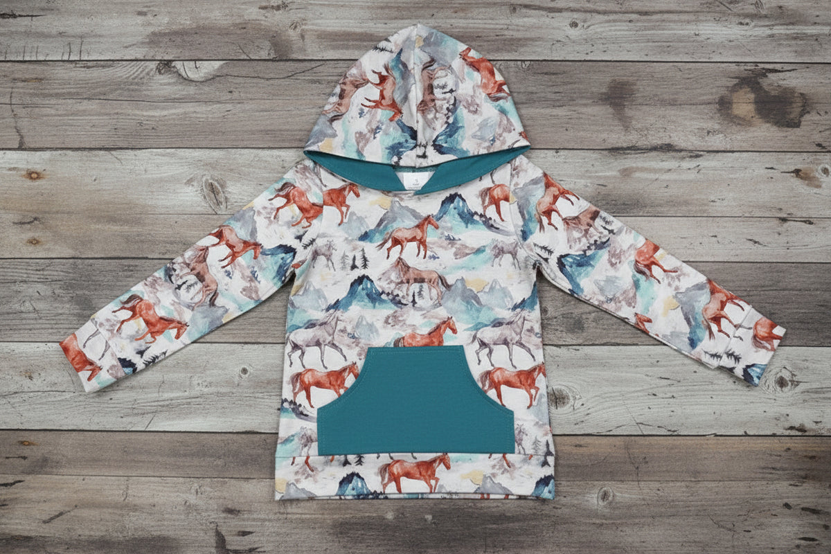 girls teal horse hoodie against barnwood