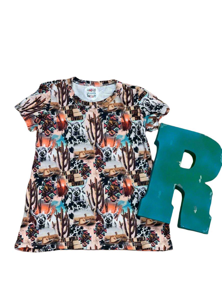 girls The World Needs More Cowboys tshirt dress against a white background with a large letter R for razels