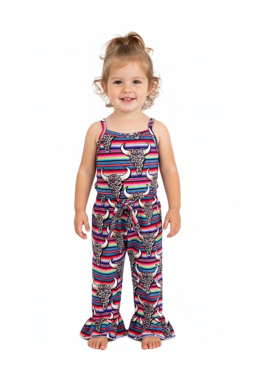 The Western Jumpsuit is here to steal the spotlight! 🤠😍 One of a kind and designed by me at Razels, this Cowgirl Outfit is an absolute showstopper with its charming design and flattering fit. The elastic waistband ensures all-day comfort, making this Serape Jumpsuit as practical as it is stylish.
How fun and Western fabulous is this Bell Bottom Romper? Featuring bold serape stripes, cow skulls, and cheetah print, it combines all the best Western elements into one stunning piece!