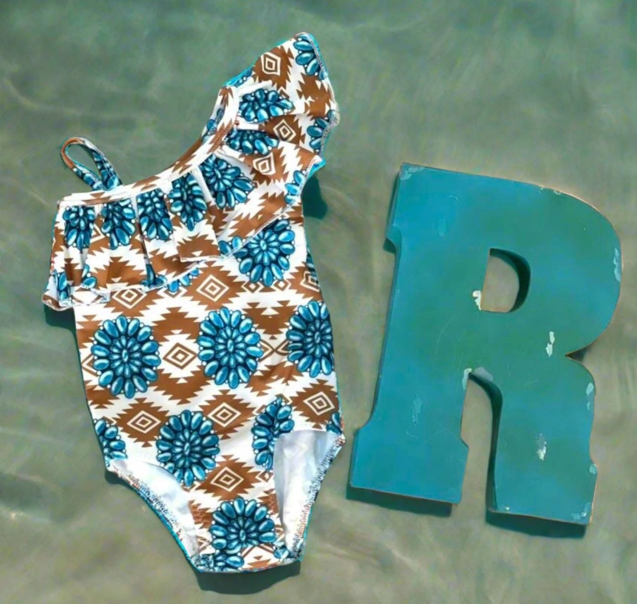 Cowgirl Swimsuit, Turquoise Conchos, Western Swimsuits, SOUTHWESTERN, Squash blossoms, Girls One piece swim, Ruffle Swimsuit, Girls' Western Swimsuit Two of our favorite things – Aztec prints and turquoise concho squash blossoms – come together in this stunning Western-inspired swimsuit! 😍 This girls' one-piece ruffle swimsuit is a must-have for little cowgirls who love bold, Southwestern style. Available 0-3 months - girls 12/14. Ships FREE $35+ order from Montana.