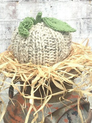 handknit large pumpkin with knit ribs along side, and a handknit leaf and vine sprouting from top! Cute!