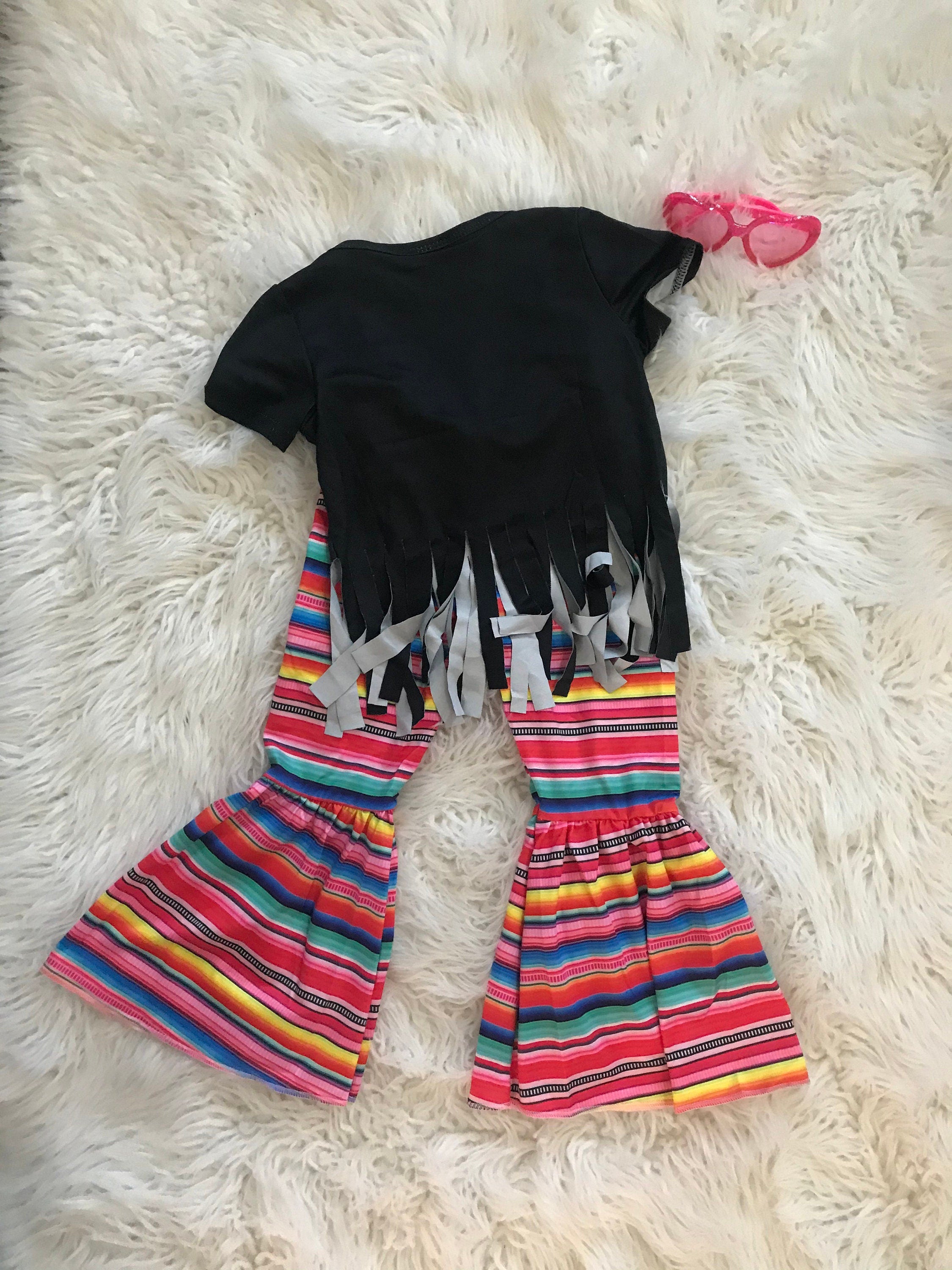 Stay Wild Girls Bell Bottom Set. Features a black Fringed Shirt with a bold "Stay Wild" design in pink and cheetah print, perfectly paired with vibrant serape-striped bell bottoms. Ships FREE with $35+ purchase.