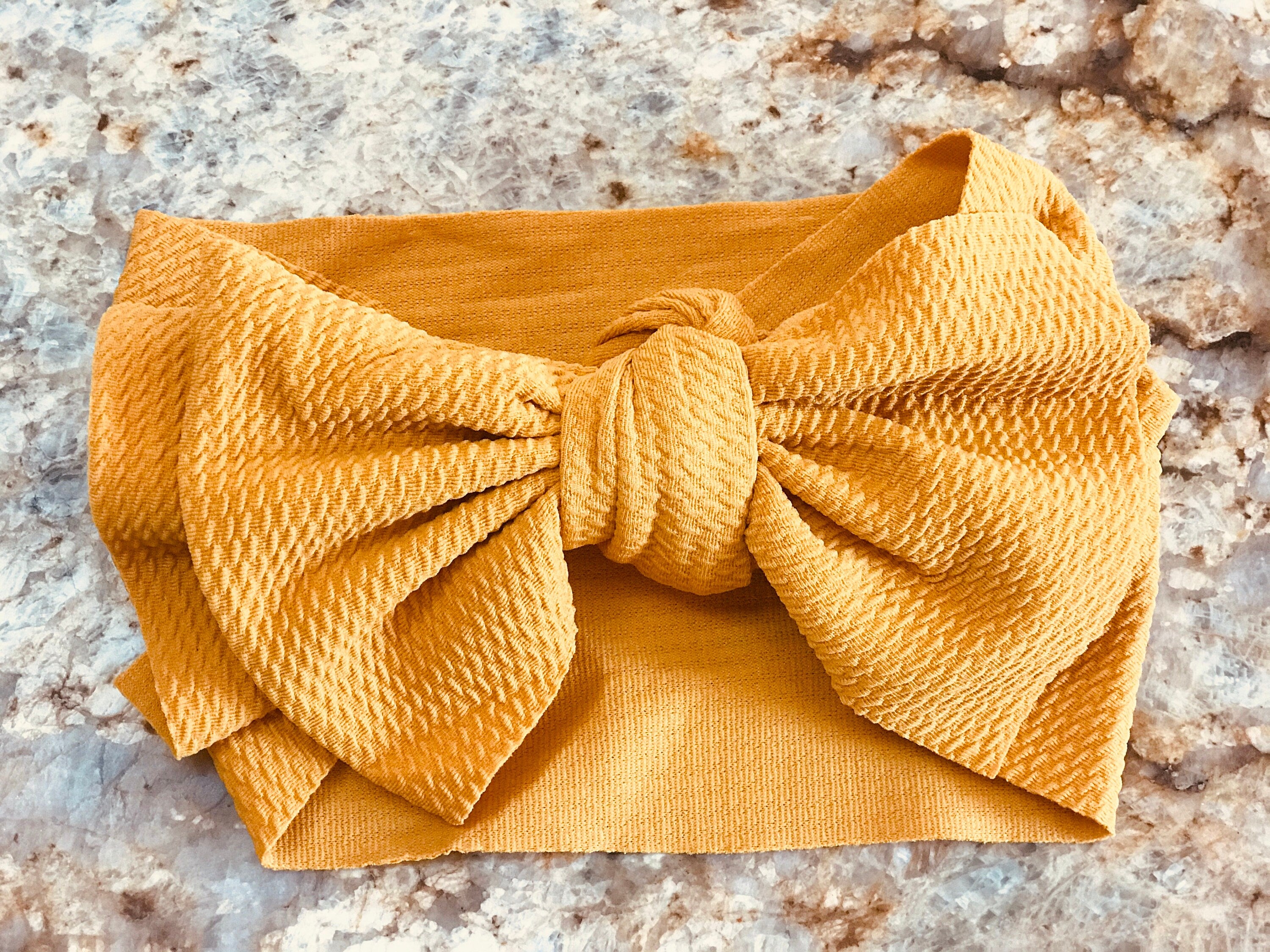 Yellow Big Bow Headband These Big Bow Headbands for babies and toddlers are the perfect finishing touch to your little one's adorable outfit (also sold by Razels 😉). Soft, stretchy, and adjustable, they provide both comfort and style! And now, they’re available in even more colors!
✔ Hand-tied, not sewn, so you can adjust for the perfect fit