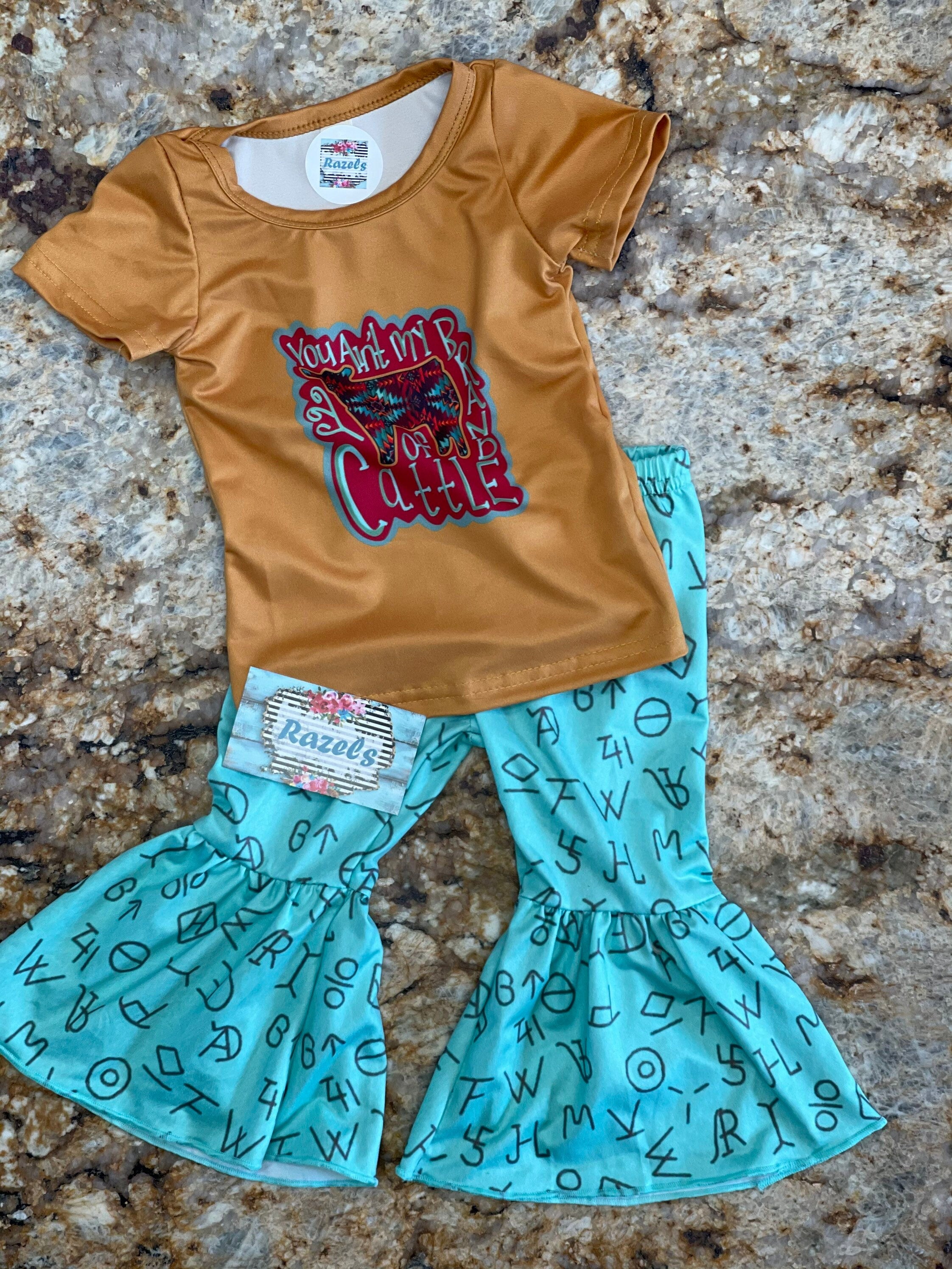 LAST ONE! 🛑 $10 CLOSEOUT – Size 3T "You Ain’t My Brand of Cattle" Bell Bottom Set | Cowgirl Outfit | Turquoise Cattle Brand Flares What a fun and sassy outfit for your little cowgirl! 🤠 This final set in size 3T includes a mustard yellow tee paired with turquoise cattle brand bell bottoms—perfect for rodeos, playdates, and everyday adventures! ✔ FINAL SALE – Only $10 plus FREE shipping from Montana on orders $35 plus!!