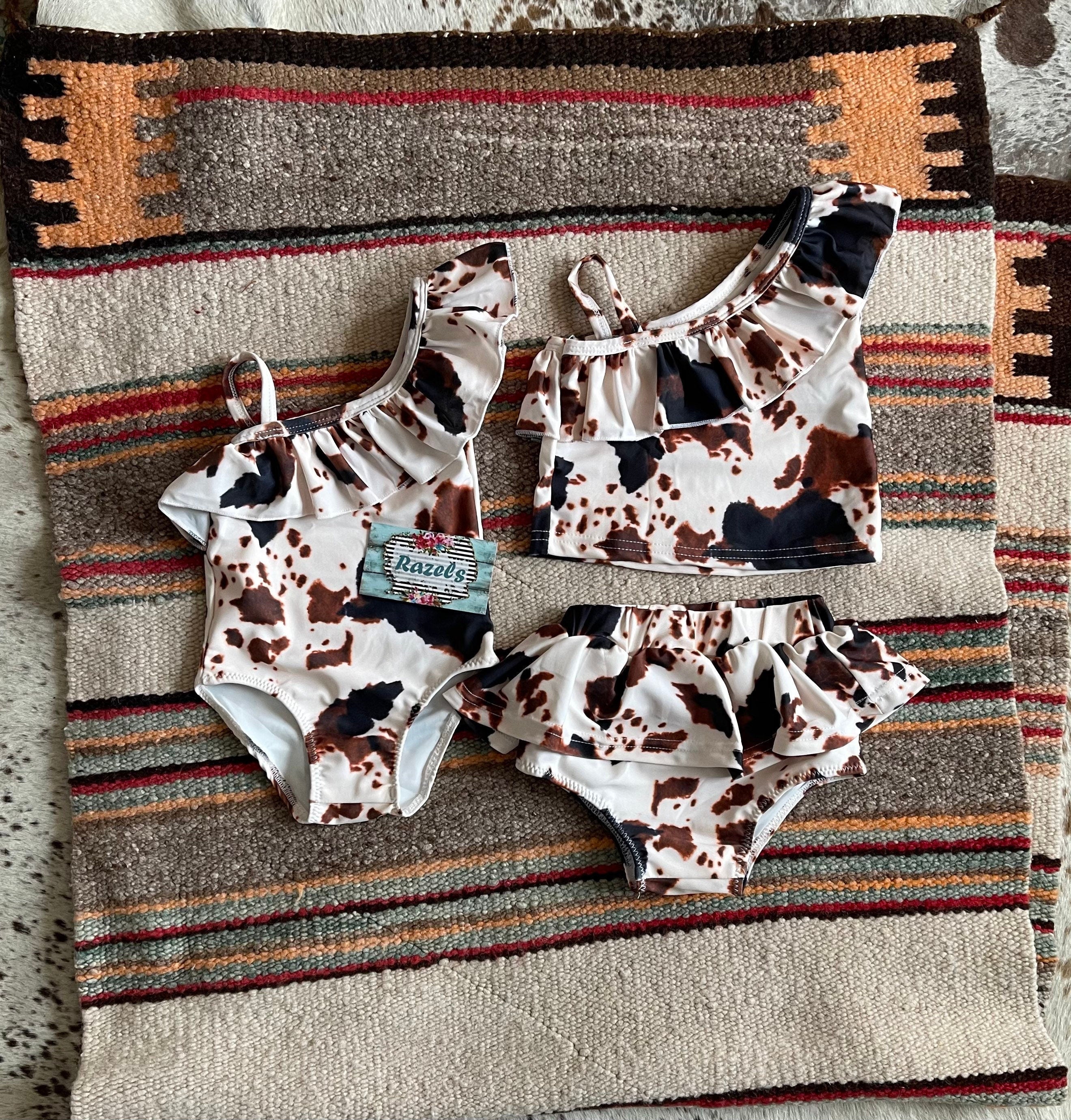 Cow Print Swim Suits are perfect for little cowboys and cowgirls!  Available Styles: Cow Print One-Piece, 2-piece tankini, or boys' Cowprint Shorts.Available in sizes 0-3 months to 8/9 years. Ship FREE with $35+ purchase.