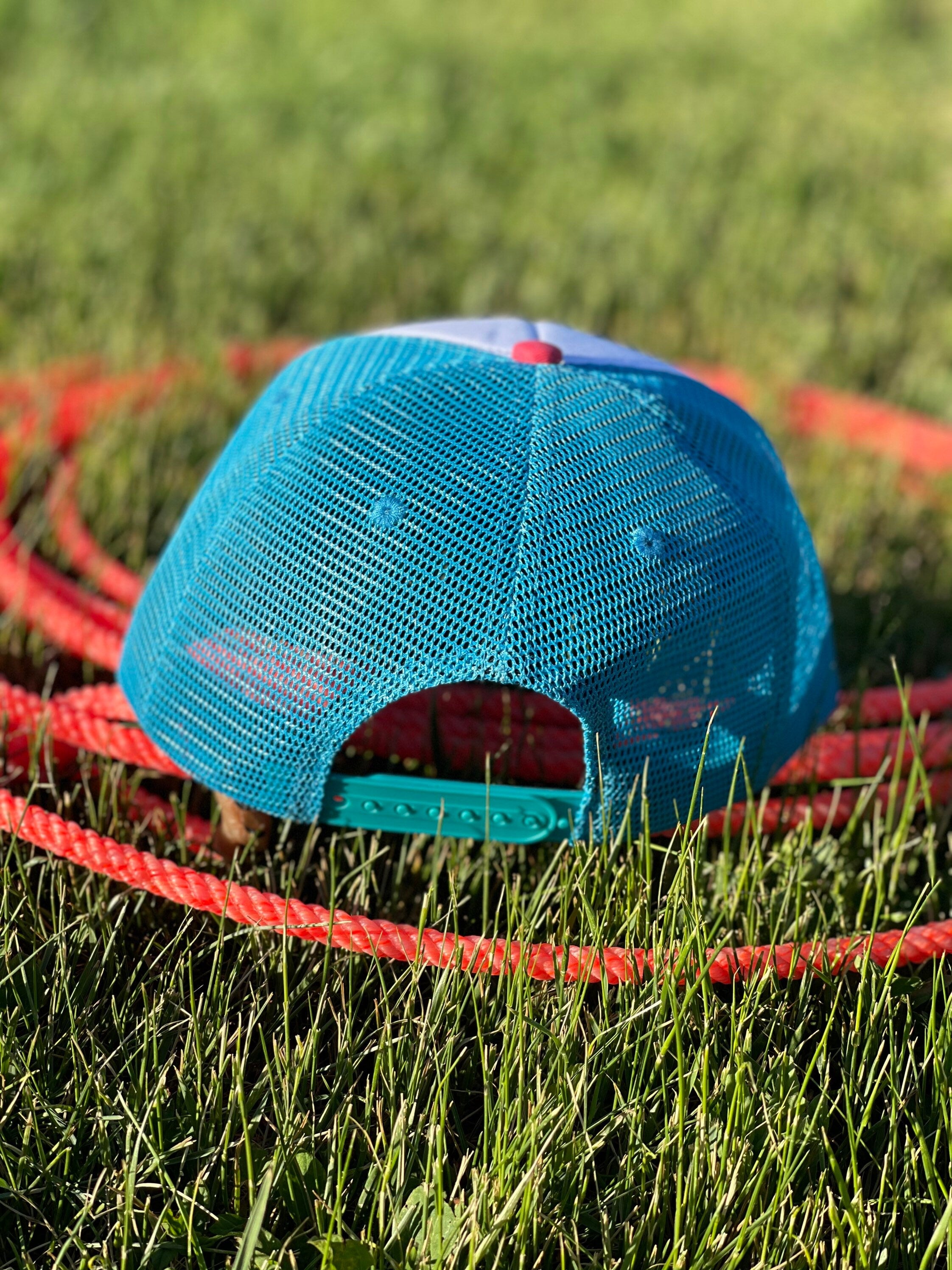 These high-quality 5-panel trucker caps are perfect for adding a playful touch to any outfit. Featuring a snapback closure for a comfortable fit and a charming Razels patch, these caps blend style with functionality.