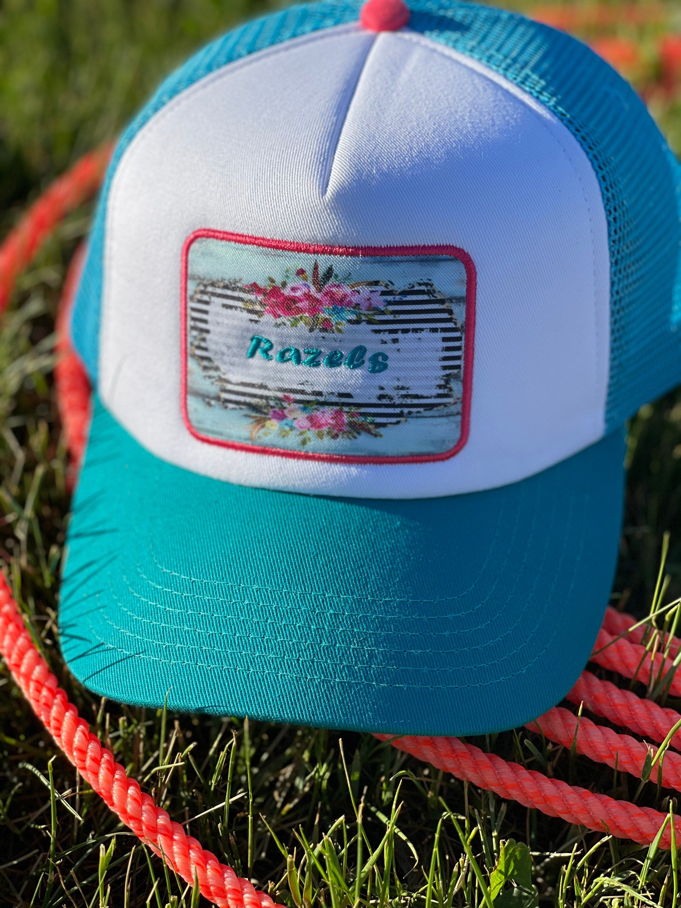These high-quality 5-panel trucker caps are perfect for adding a playful touch to any outfit. Featuring a snapback closure for a comfortable fit and a charming Razels patch, these caps blend style with functionality.