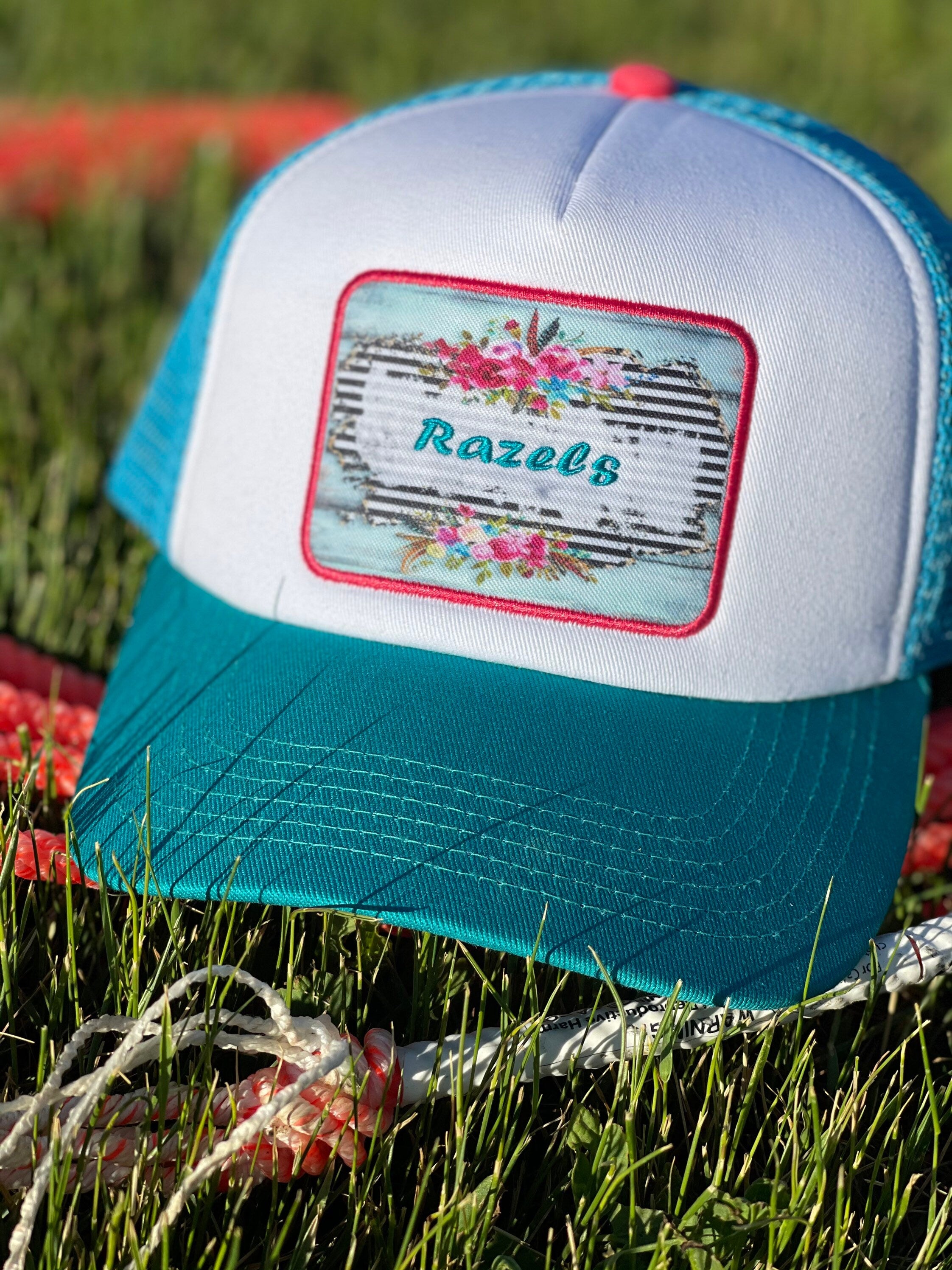 These high-quality 5-panel trucker caps are perfect for adding a playful touch to any outfit. Featuring a snapback closure for a comfortable fit and a charming Razels patch, these caps blend style with functionality.