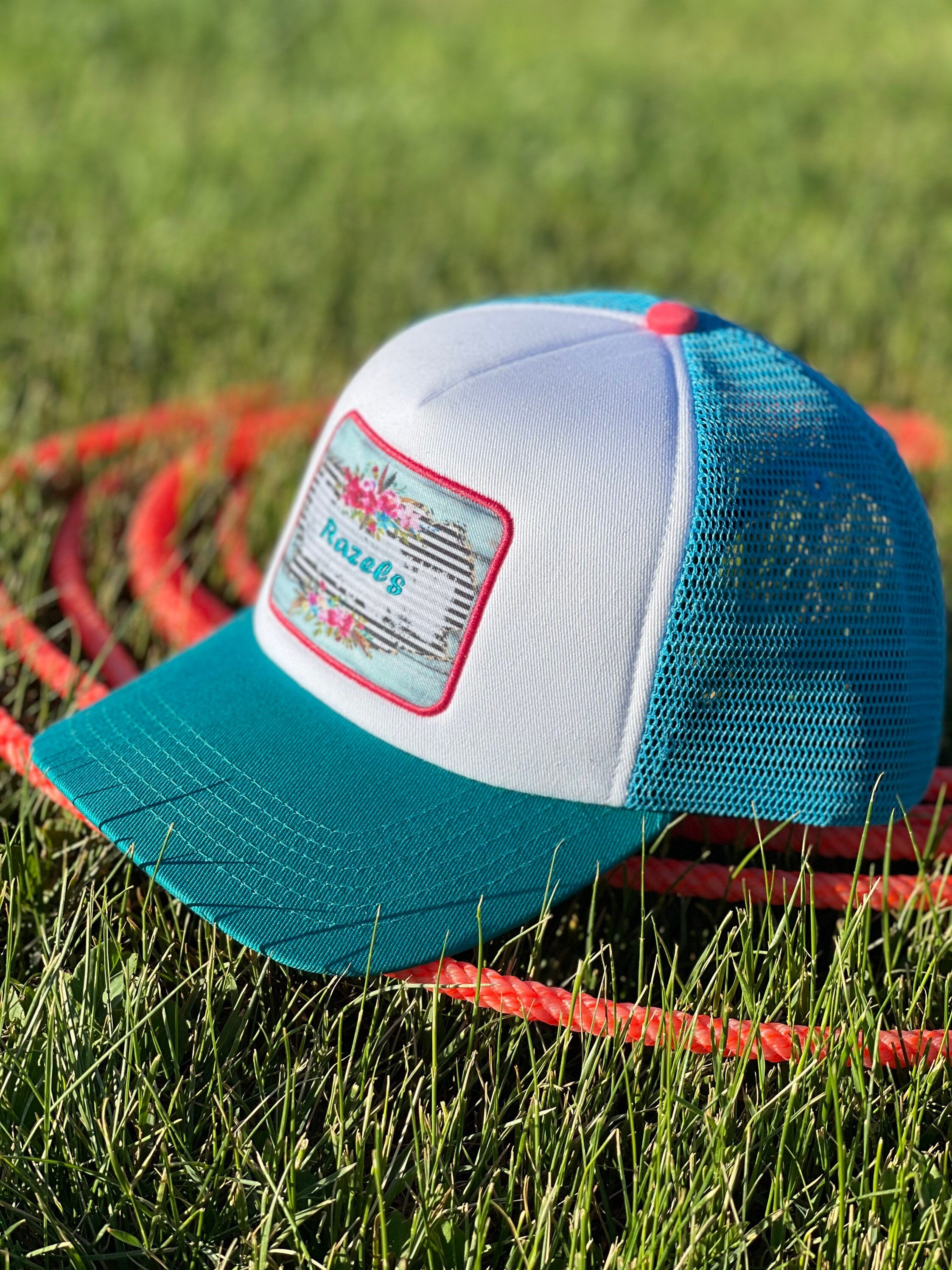 These high-quality 5-panel trucker caps are perfect for adding a playful touch to any outfit. Featuring a snapback closure for a comfortable fit and a charming Razels patch, these caps blend style with functionality.