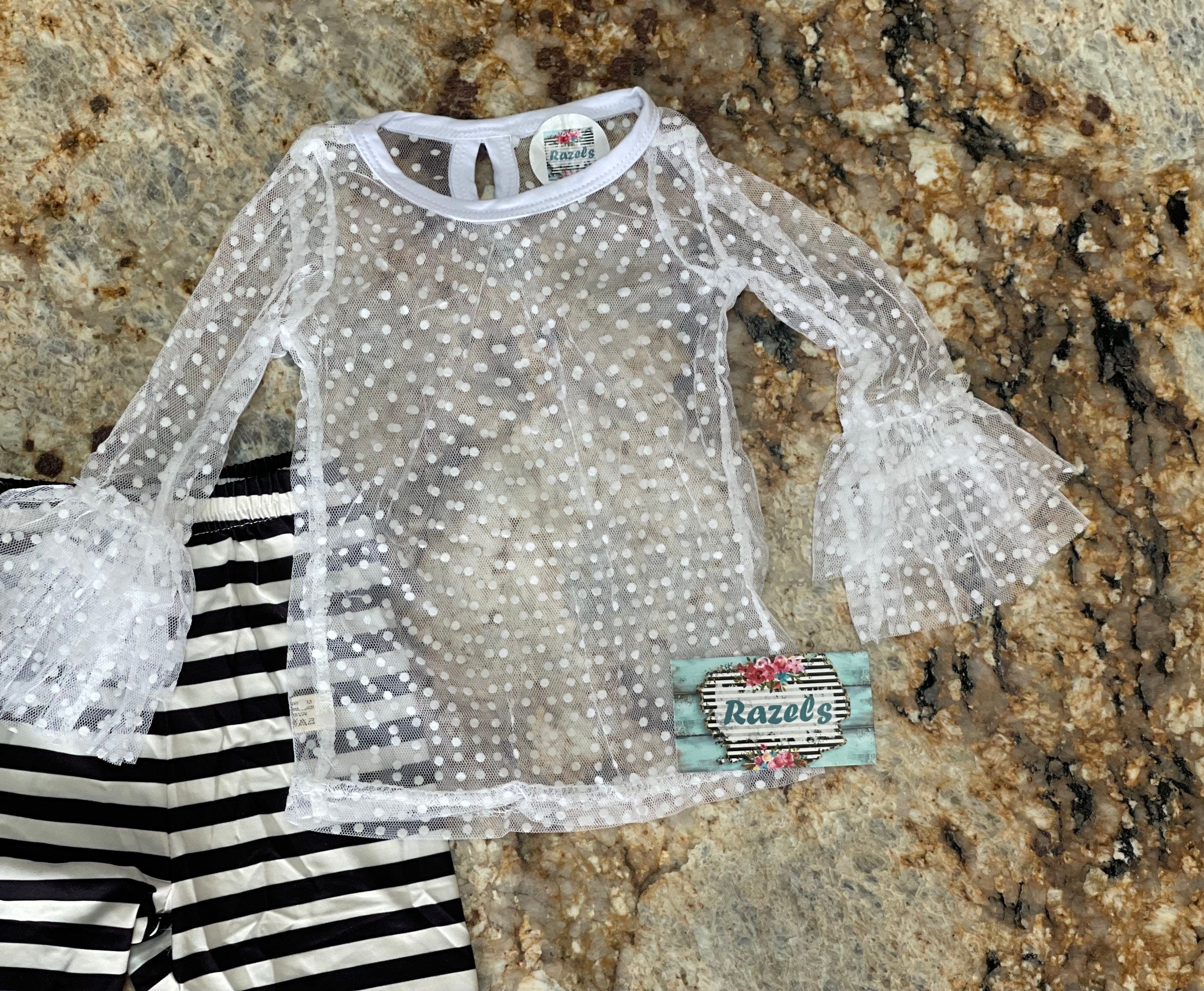 Black and White Lace Outfit – A Stunning 3-Piece Set for Little Girls. This Girls' Lace Top, Tunic Tank, and Striped Pants set is a timeless and elegant choice for special occasions. Whether for a family gathering, formal event, or a more somber occasion, this outfit is as versatile as it is stylish.
3 Piece set includes lace  ruffle shirt, tunic tank and striped pants with a lace hem. This set ships FREE from Montana with $35+ purchase from RAZELS.