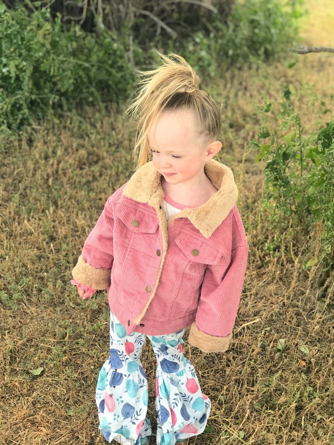 Jernie modeling pumpkin bell bottom outfit and Pink sherpa coat