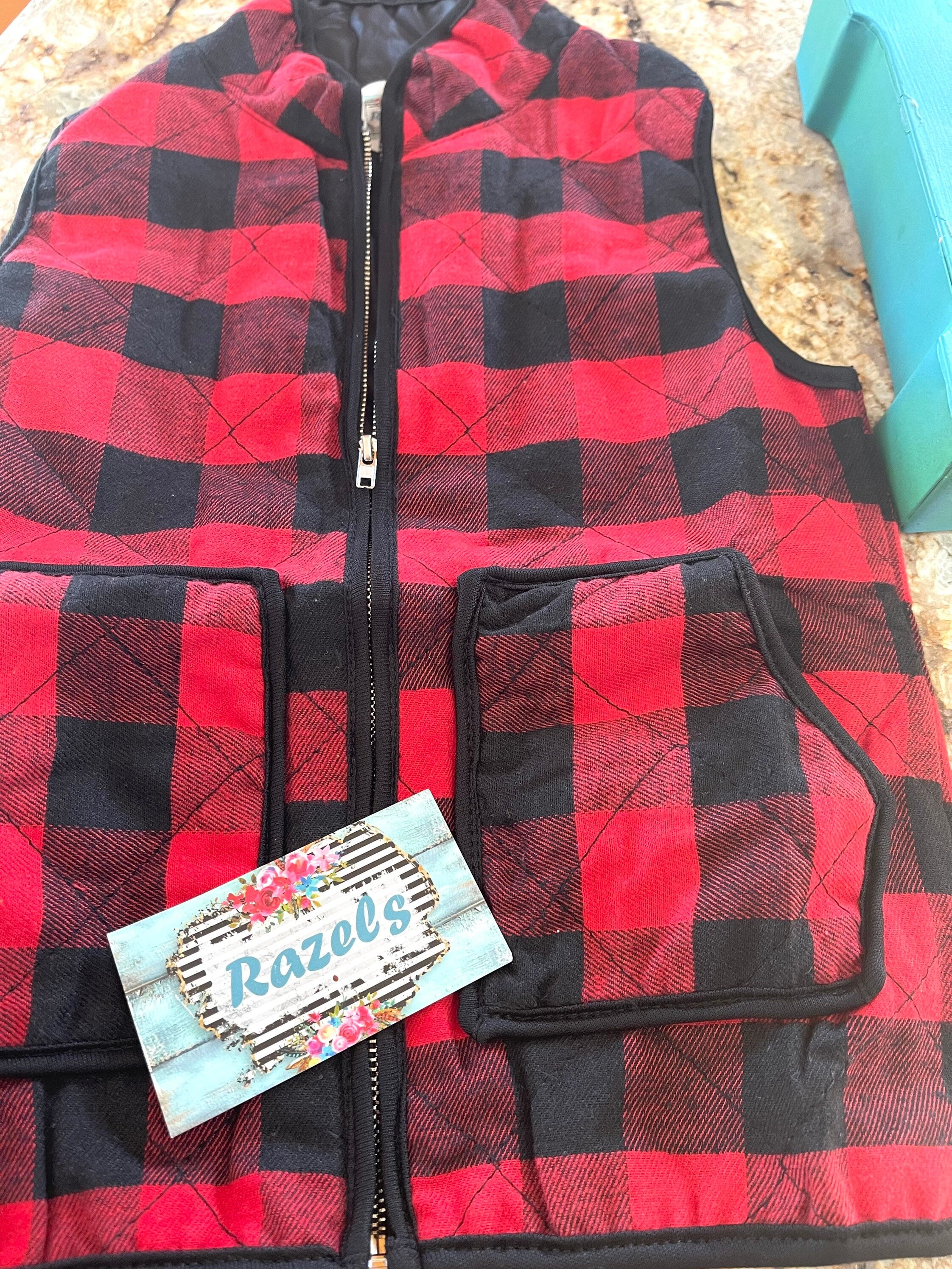 kids red and black buffalo check vest. Christmas Season Vest features a quilted design, zipper and two front pockets.