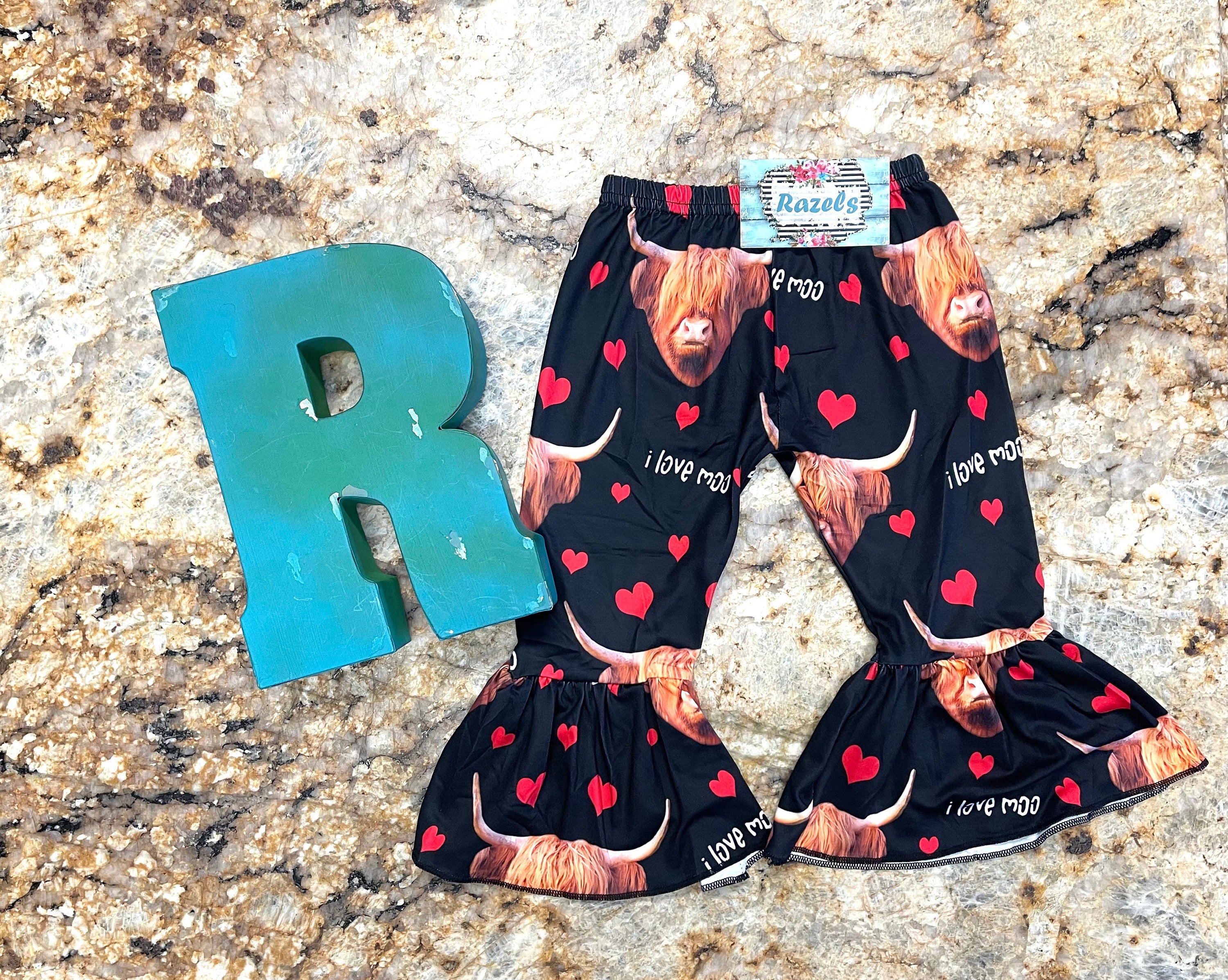 Girls Black bell bottom pants that feature Scottish highlander cows, red hearts and the words I Love MOO