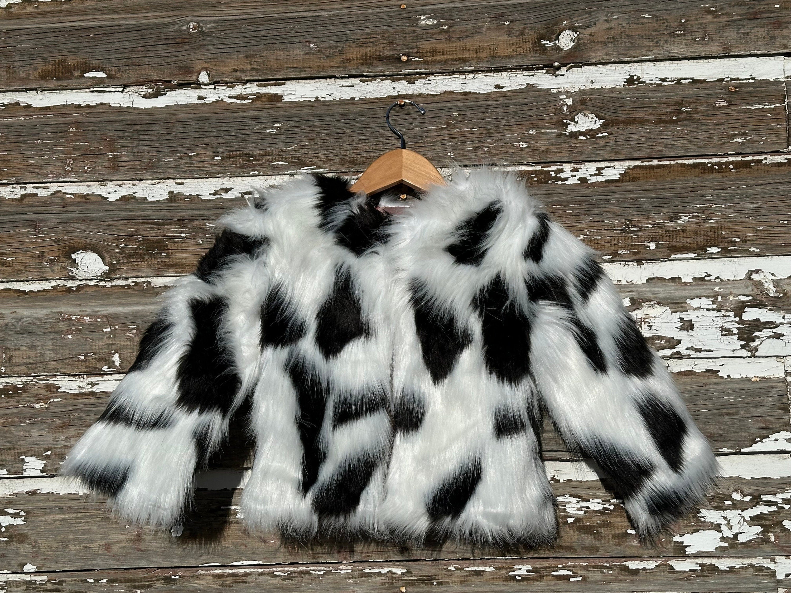 Girls fur coat features a fabulous shaggy fur exterior, silky smooth lining, and convenient eye and hook closures. She’ll feel and look like a princess in this stunning coat from Razels.