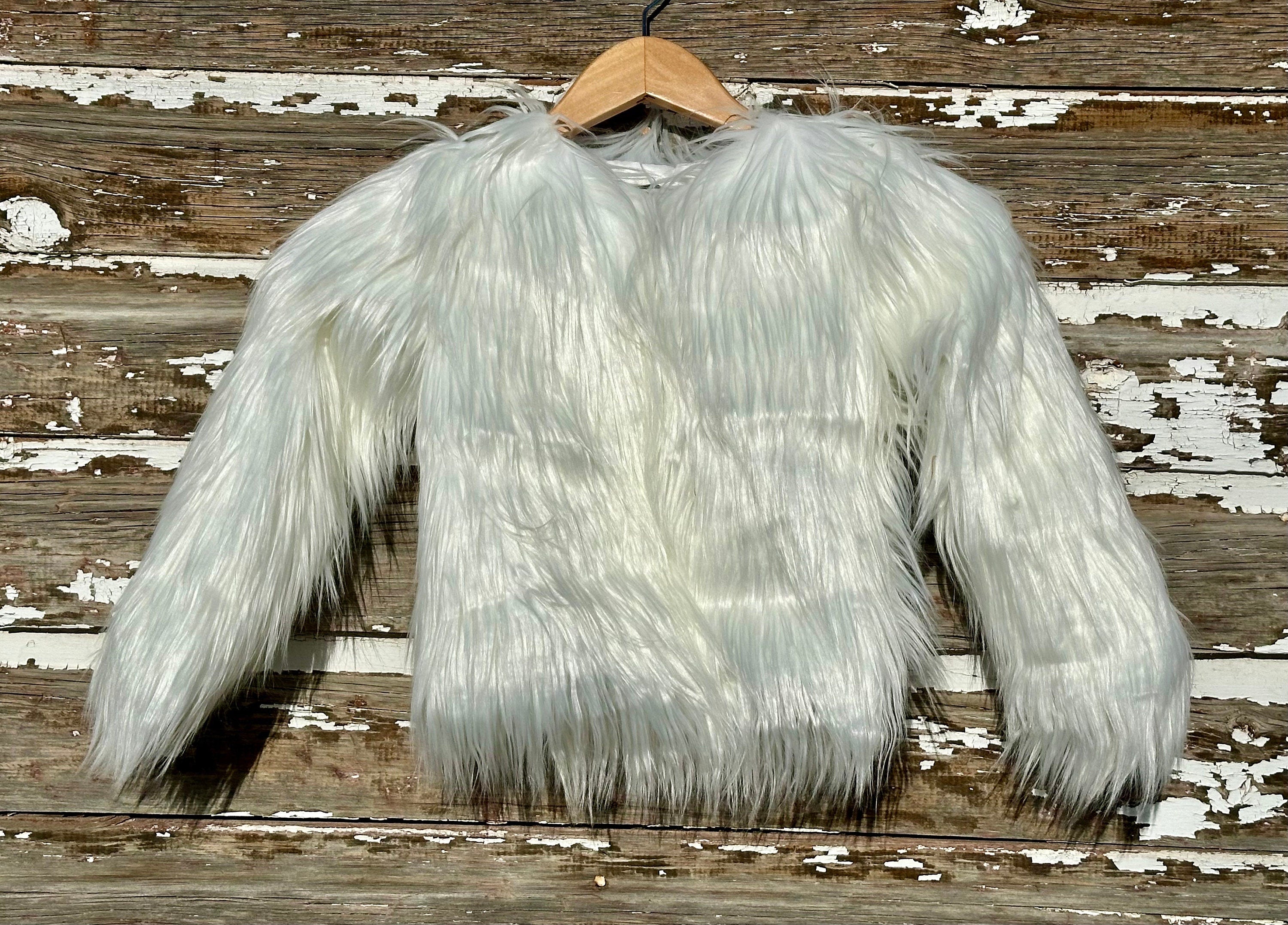 Girls fur coat features a fabulous shaggy fur exterior, silky smooth lining, and convenient eye and hook closures. She’ll feel and look like a princess in this stunning coat from Razels.