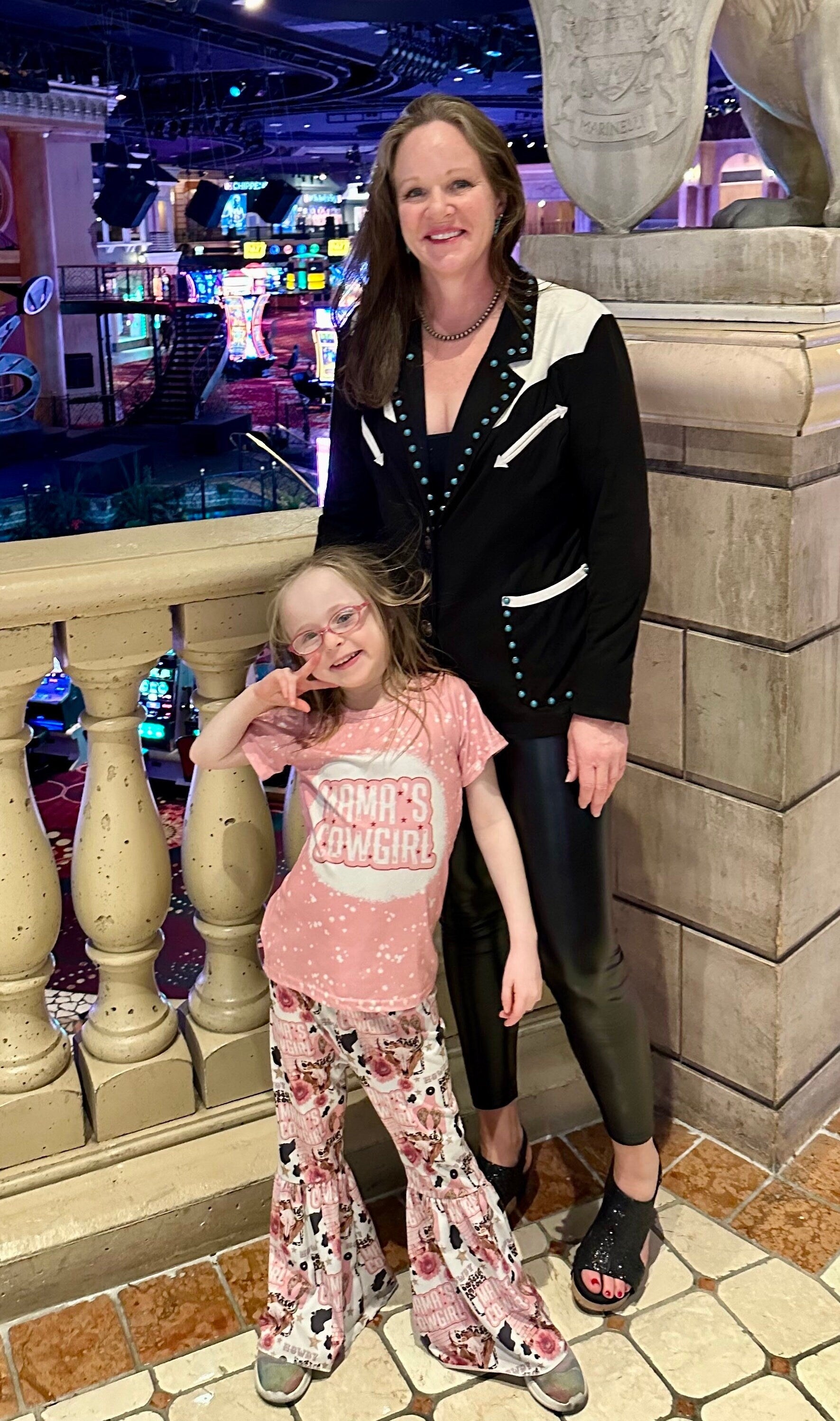 Mama’s Cowgirl Bell Bottom Outfit features a pink bleach-splattered tee with Mama's Cowgirl on the front and the bell bottom pants feature the funnest cowgirl motif with cheetah rodeo back numbers, disco balls, cow skulls, cowprint, and gold stars!