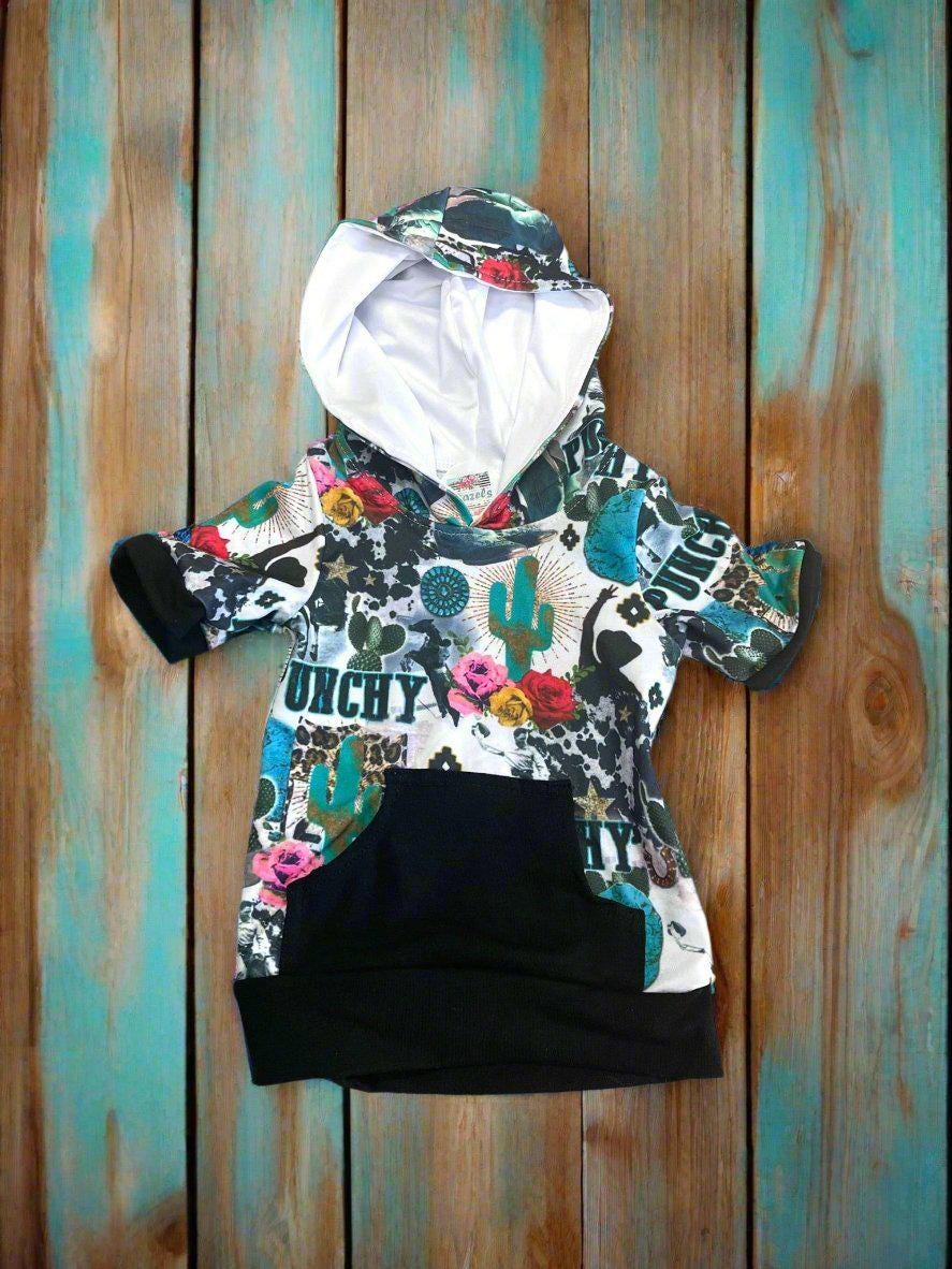 Girls Cowgirl Outfit | Western Hoodie Jogger Set for Kids This Girls PUNCHY Cowgirl Outfit is full of retro cowboy vibes. This Western outfit features an allover Western print with matching jogger pants and a lightweight, short-sleeved hoodie top.