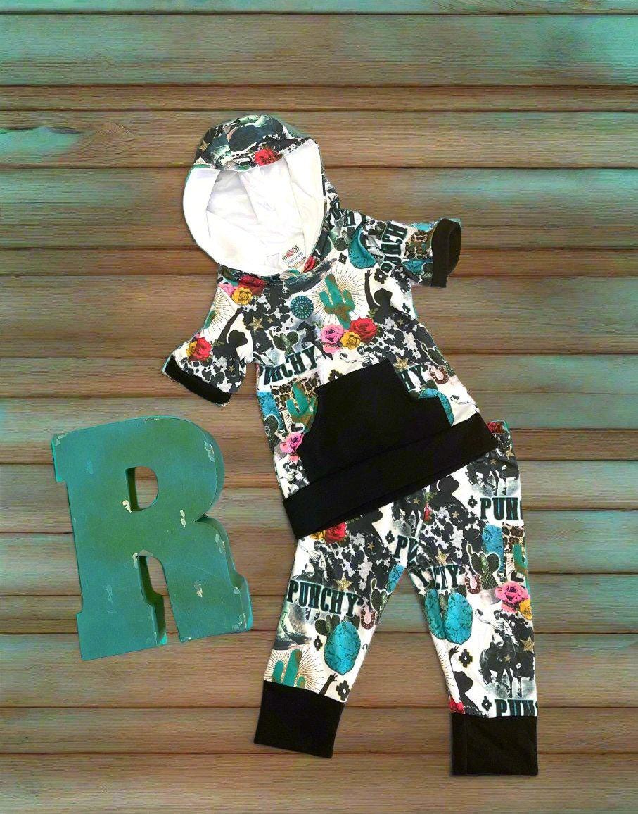 Girls Cowgirl Outfit | Western Hoodie Jogger Set for Kids This Girls PUNCHY Cowgirl Outfit is full of retro cowboy vibes. This Western outfit features an allover Western print with matching jogger pants and a lightweight, short-sleeved hoodie top.