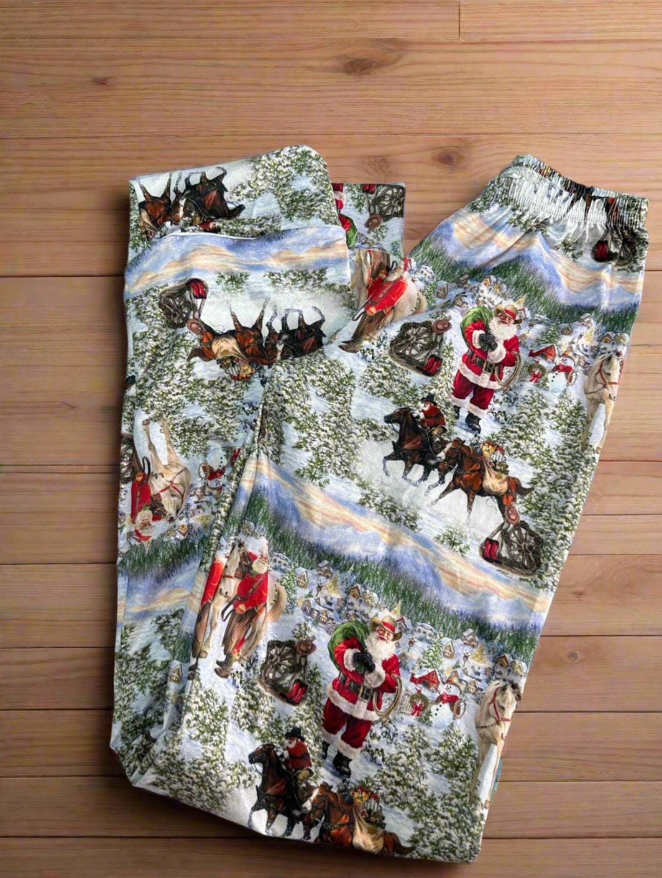 ORIGINAL Cowboy Santa Pajamas featuring Western Santa and his best horses. This button-down pajama style is perfect for the whole family.
