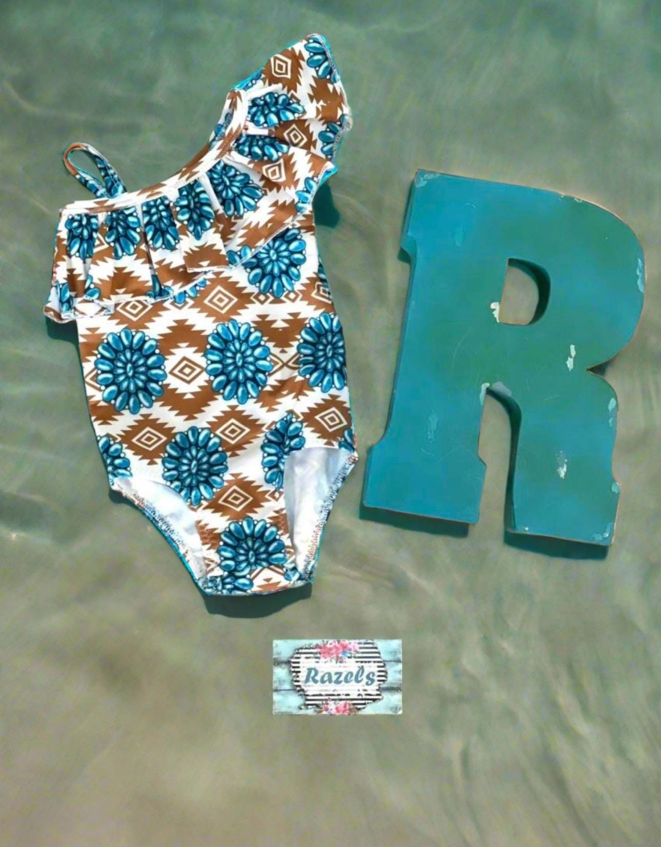 Cowgirl Swimsuit, Turquoise Conchos, Western Swimsuits, SOUTHWESTERN, Squash blossoms, Girls One piece swim, Ruffle Swimsuit, Girls' Western Swimsuit Two of our favorite things – Aztec prints and turquoise concho squash blossoms – come together in this stunning Western-inspired swimsuit! 😍 This girls' one-piece ruffle swimsuit is a must-have for little cowgirls who love bold, Southwestern style. Available 0-3 months - girls 12/14. Ships FREE $35+ order from Montana.