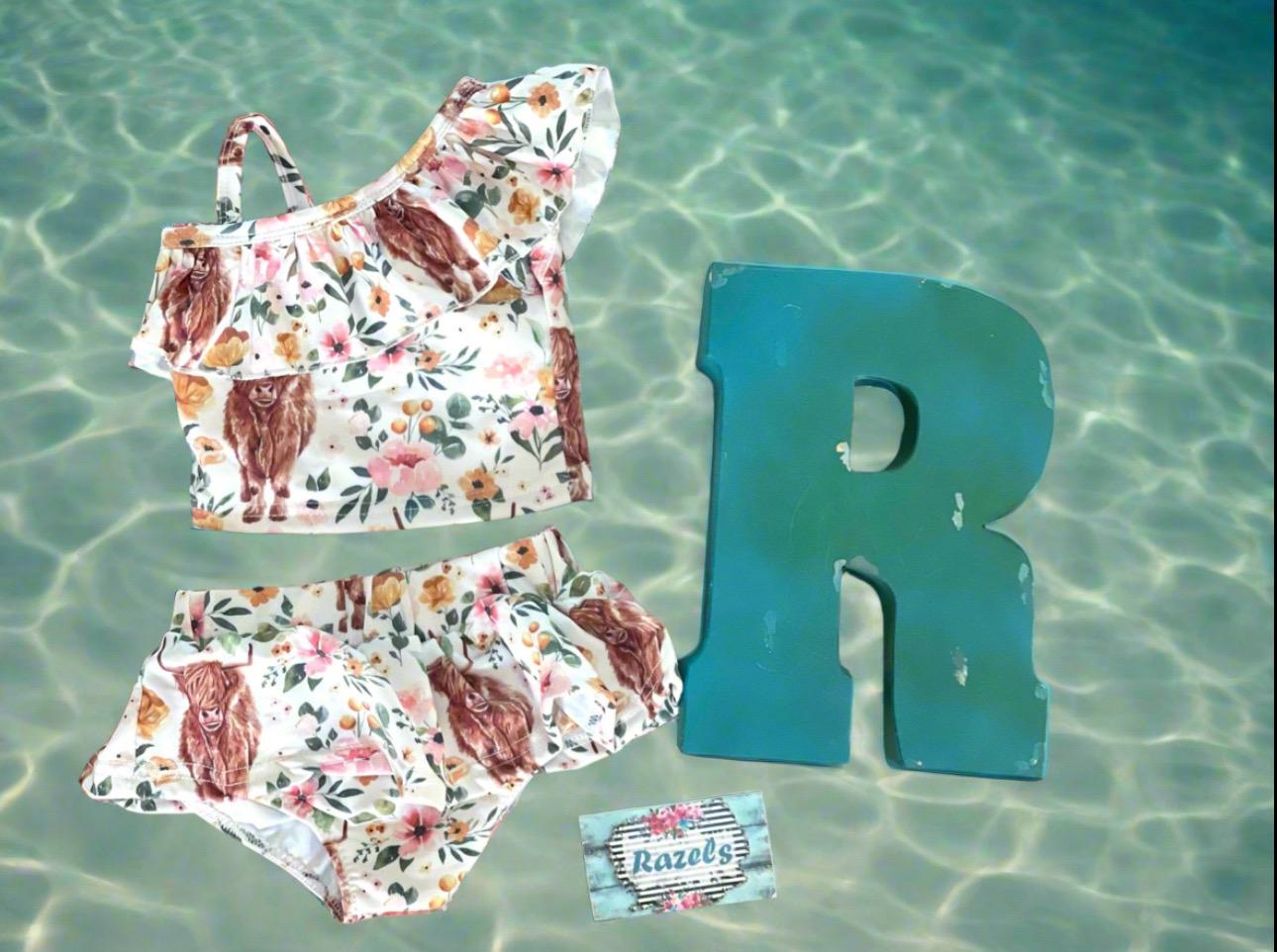 Highland Cow Swimsuit – The Sweetest Western Tankini! 🐂💖
Calling all Highland Cow lovers! This adorable Highland Cow Swimsuit features the funnest (yes, that's a word for this cuteness!) Scottish Highlander Cows and Flowers in a stylish tankini design. With a ruffled neckline and a skirted bottom, this Cowgirl Swimsuit for Kids is as sweet as it is fun! 🌸🐂
✔ Available Sizes: 0-3 months to 8/9!