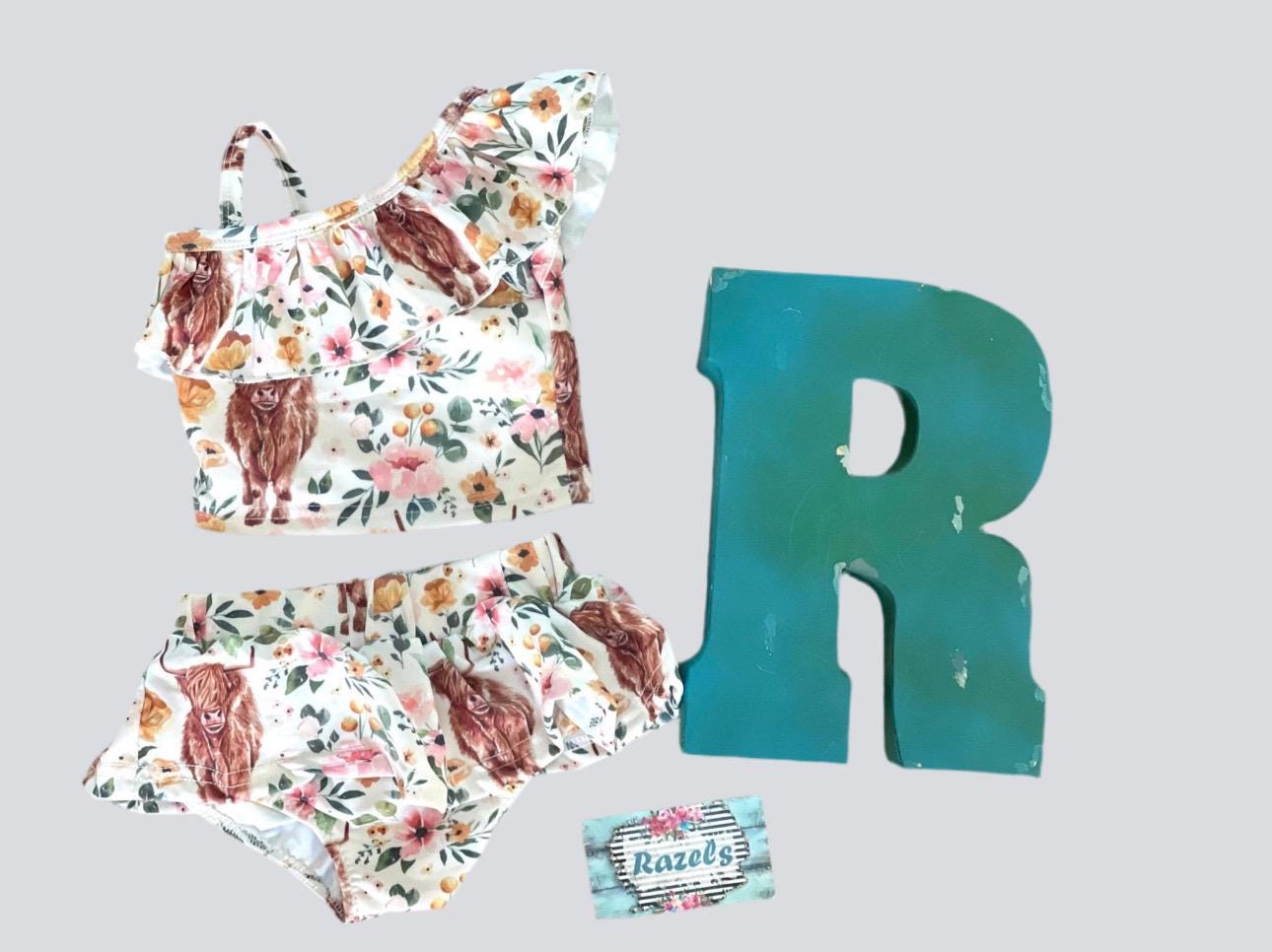 Highland Cow Swimsuit – The Sweetest Western Tankini! 🐂💖
Calling all Highland Cow lovers! This adorable Highland Cow Swimsuit features the funnest (yes, that's a word for this cuteness!) Scottish Highlander Cows and Flowers in a stylish tankini design. With a ruffled neckline and a skirted bottom, this Cowgirl Swimsuit for Kids is as sweet as it is fun! 🌸🐂
✔ Available Sizes: 0-3 months to 8/9!