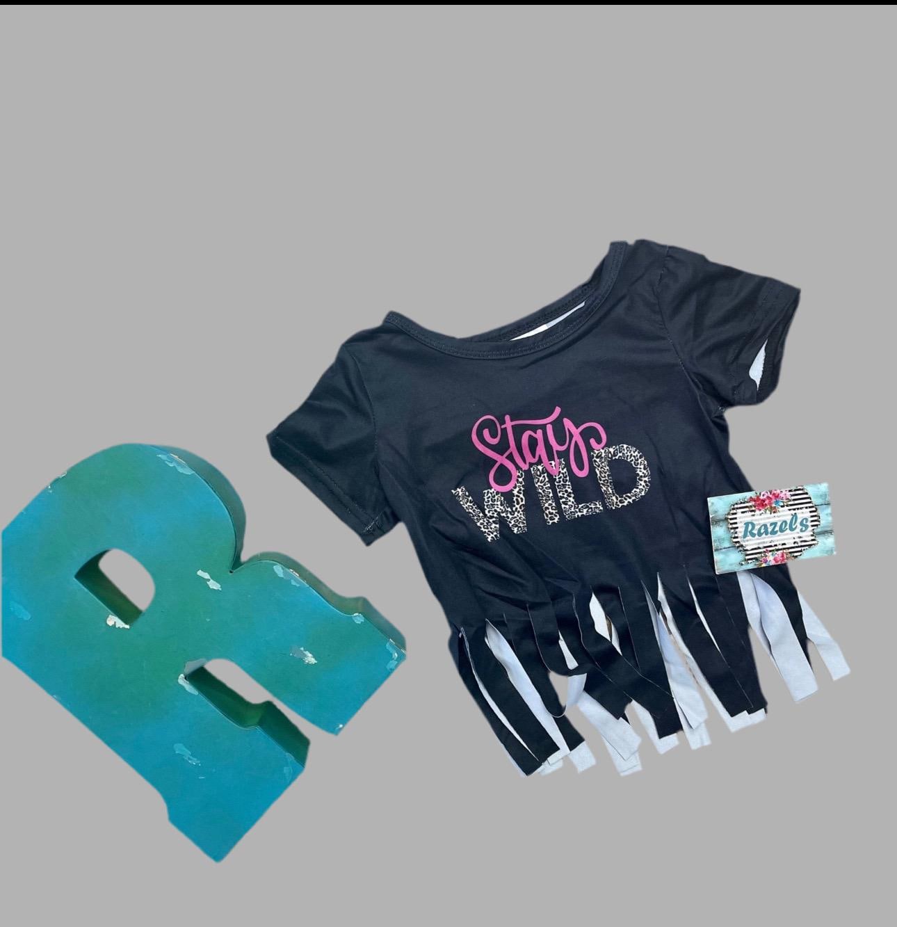 Stay Wild Girls Bell Bottom Set. Features a black Fringed Shirt with a bold "Stay Wild" design in pink and cheetah print, perfectly paired with vibrant serape-striped bell bottoms. Ships FREE with $35+ purchase.