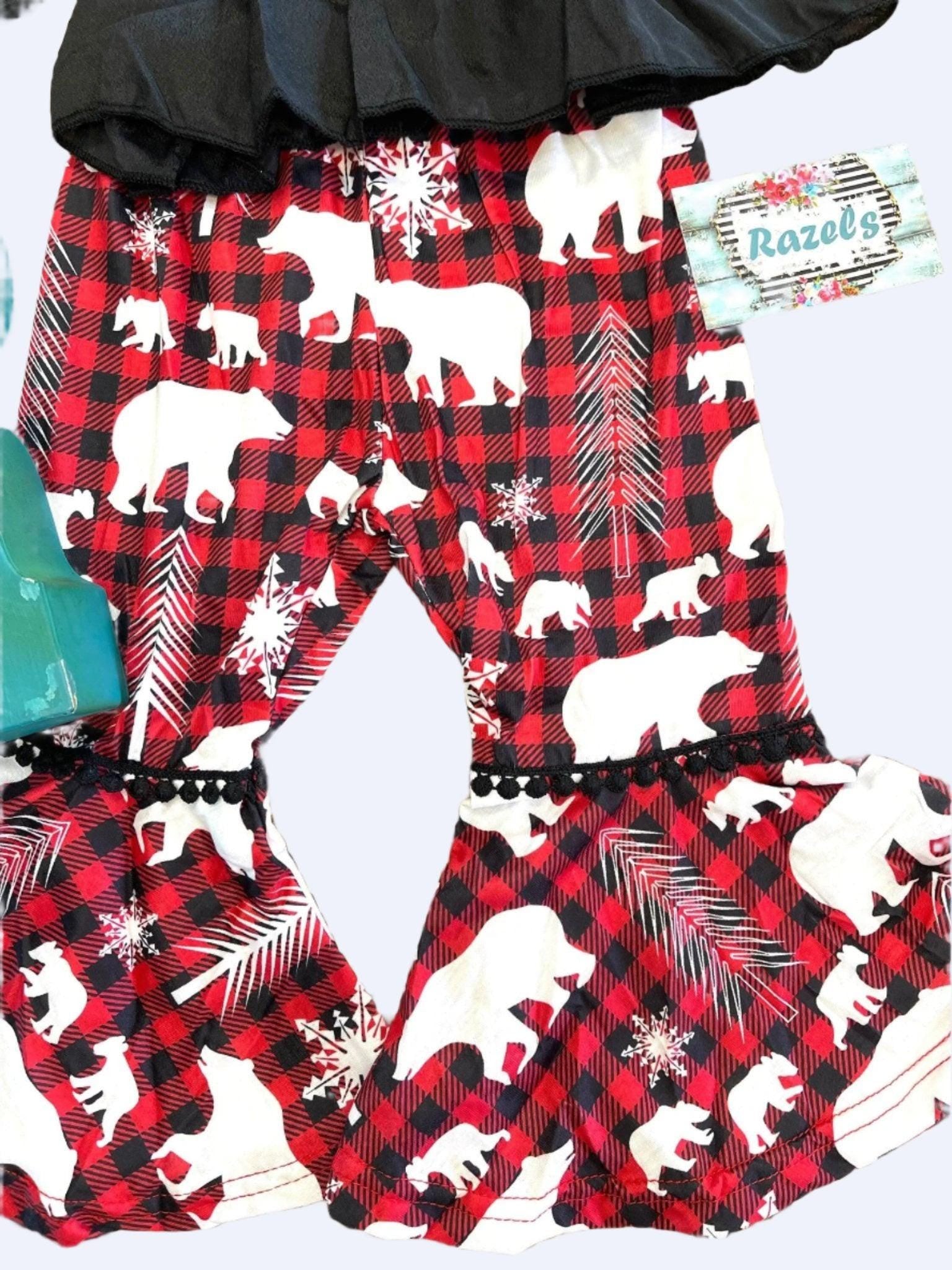 Toddler Girl Christmas outfit featuring a stunning black blouse paired with holiday-themed pants featuring red buffalo plaid bell bottoms adorned with white bears and trees.