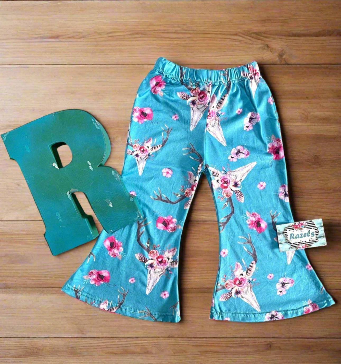 Baby & Toddler Bell Bottoms in a fun flower skull boho print! Perfectly stretchy with the ideal flare, these versatile pants are great for dressing up or down. and are machine washable! Shop Razels for more! Ships FREE with $35+ purchase