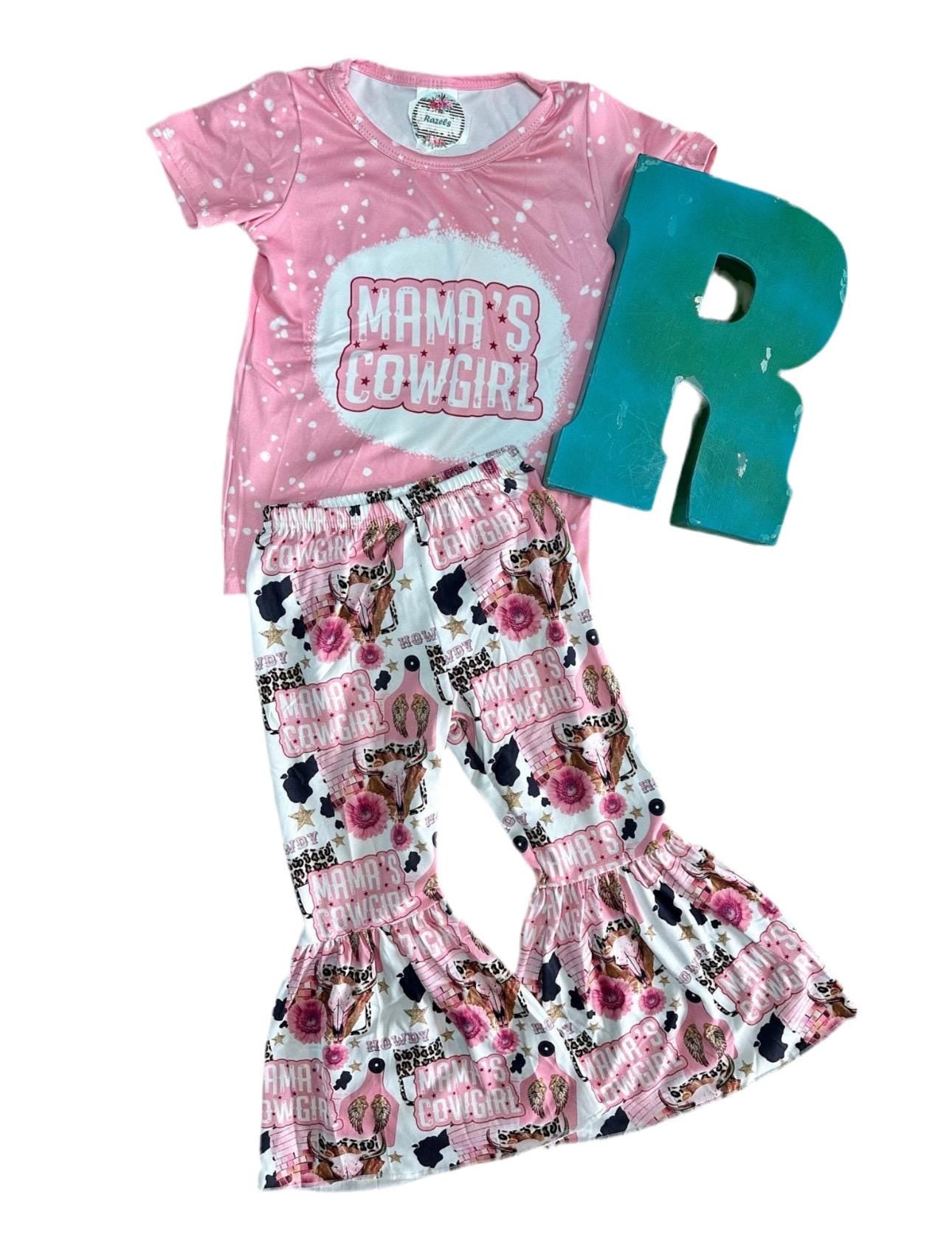 Mama’s Cowgirl Bell Bottom Outfit features a pink bleach-splattered tee with Mama's Cowgirl on the front and the bell bottom pants feature the funnest cowgirl motif with cheetah rodeo back numbers, disco balls, cow skulls, cowprint, and gold stars!