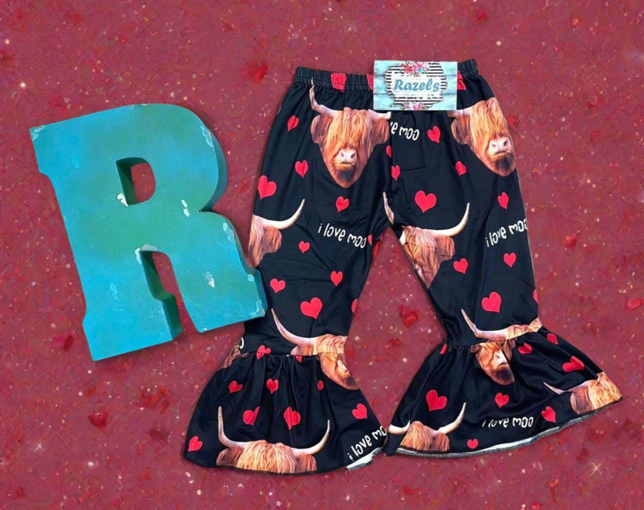 Girls Black bell bottom pants that feature Scottish highlander cows, red hearts and the words I Love MOO