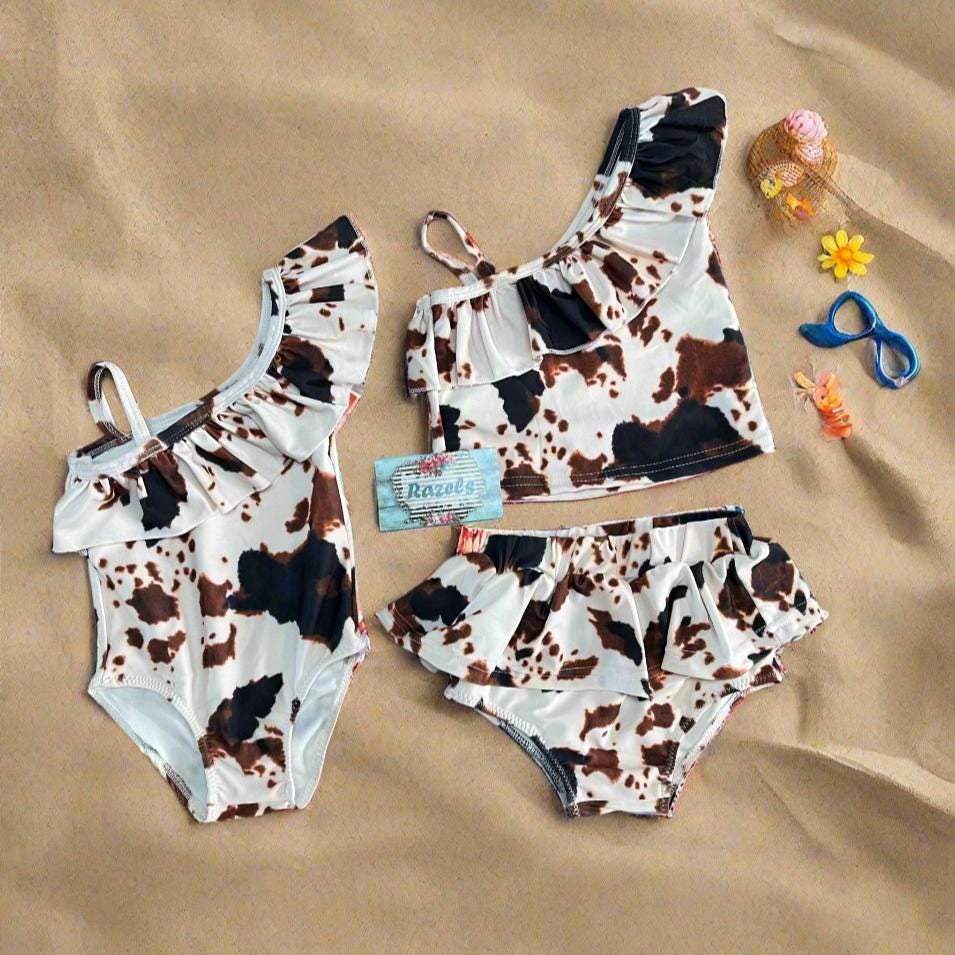 Cow Print Swim Suits are perfect for little cowboys and cowgirls! Available Styles: Cow Print One-Piece, 2-piece tankini, or boys' Cowprint Shorts.Available in sizes 0-3 months to 8/9 years. Ship FREE with $35+ purchase.